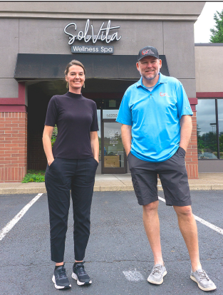 Tonie Lough and Chad Jackson, co-founders of SolVita Wellness Spa, standing in front of the spa's Tigard, Oregon location