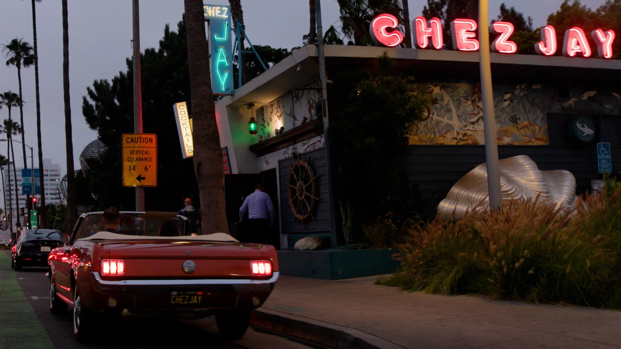 Vintage Red Car Parked Outside Chez Jay at Sunset