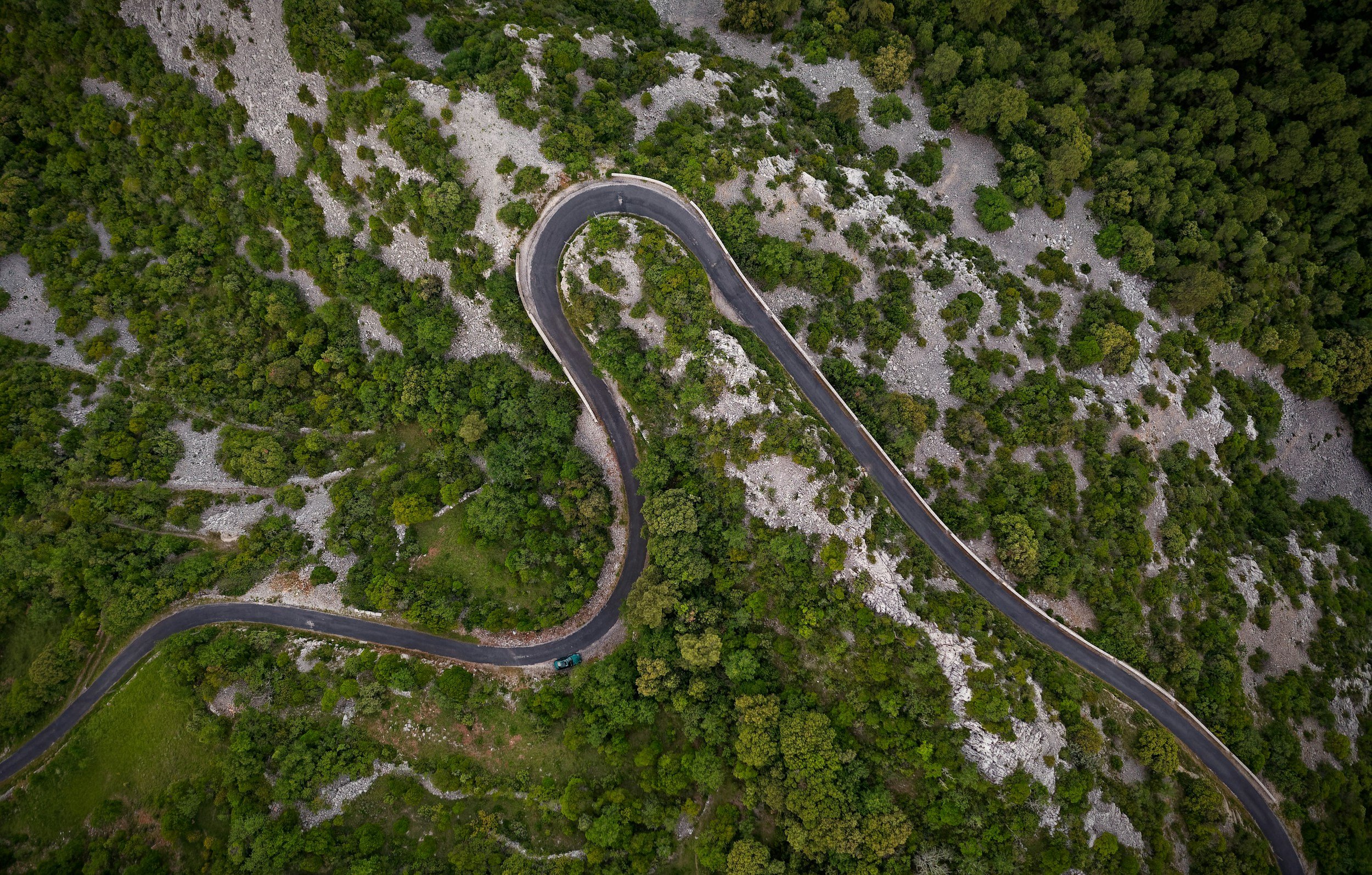 aerial view of a road with sharp curve