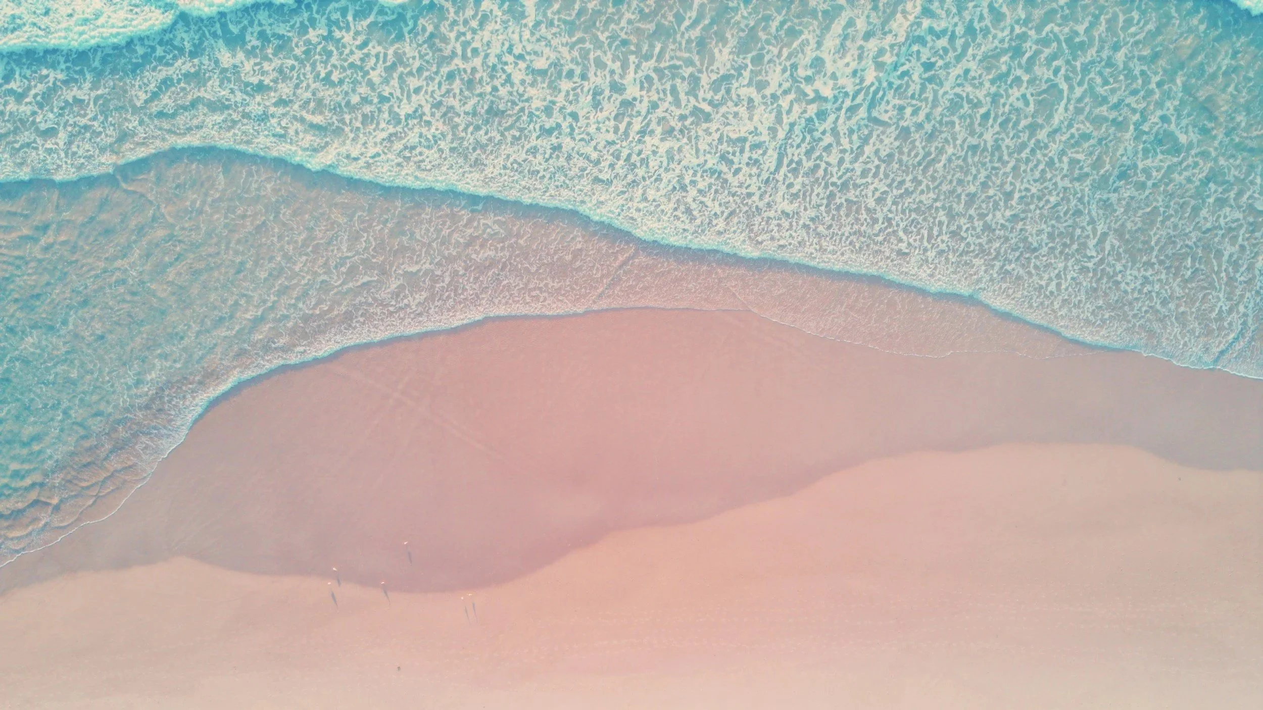 Aerial view of ocean tide on the beach.