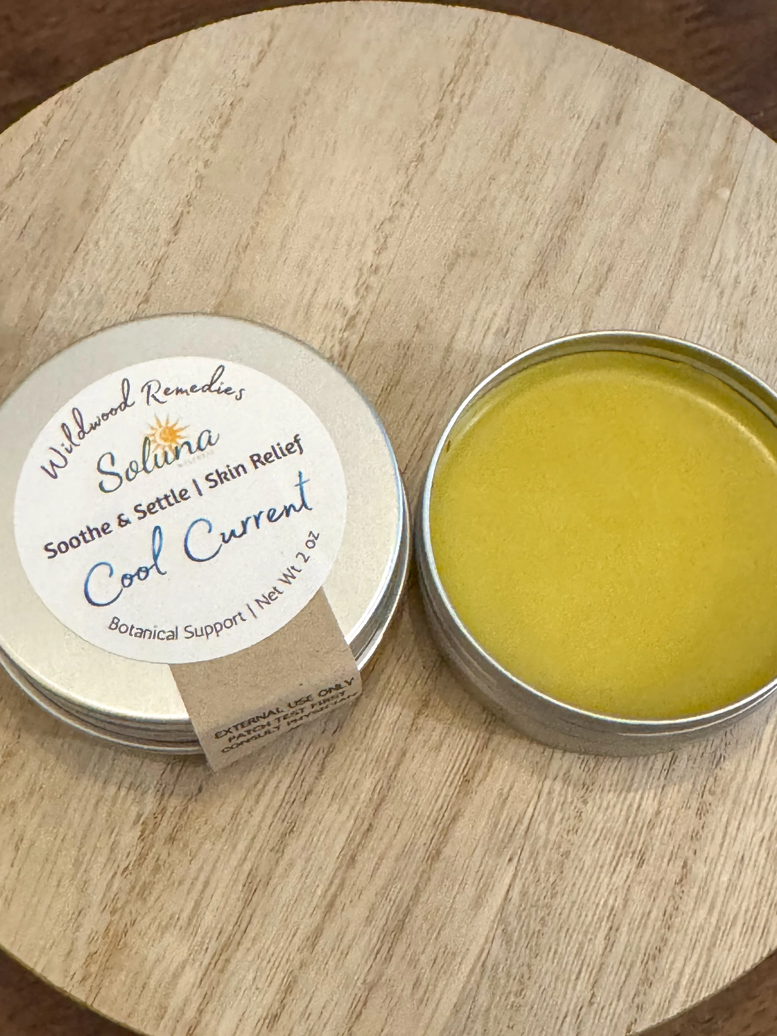 Texture shot of solar-infused herbal salve with yellow dock and milky oats for reactive skin.