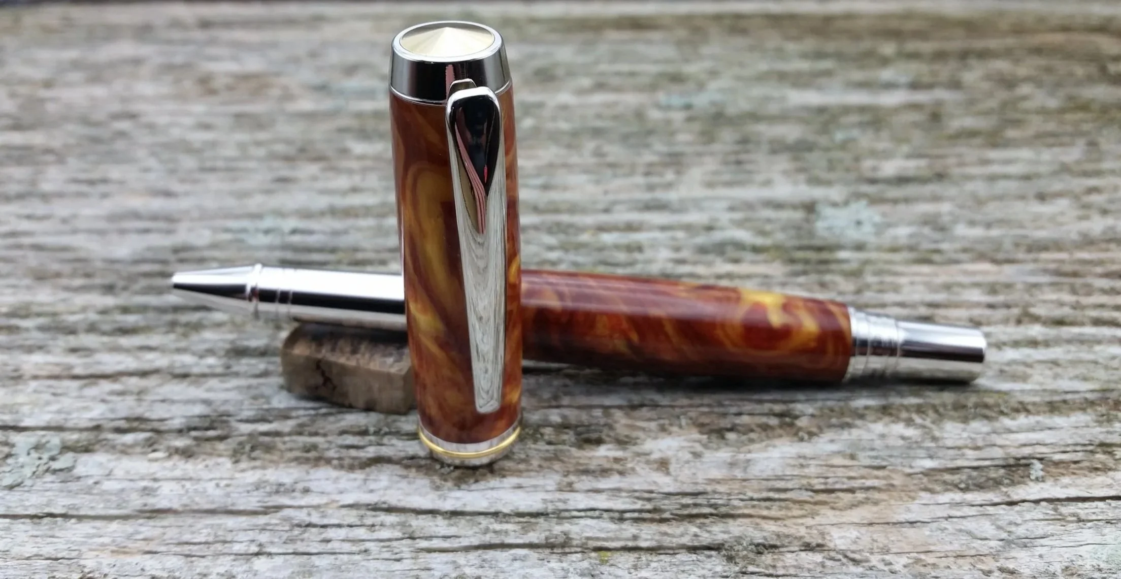 Parus Pen rollerball pen with rhodium and gold hardware and swirled amber resin
