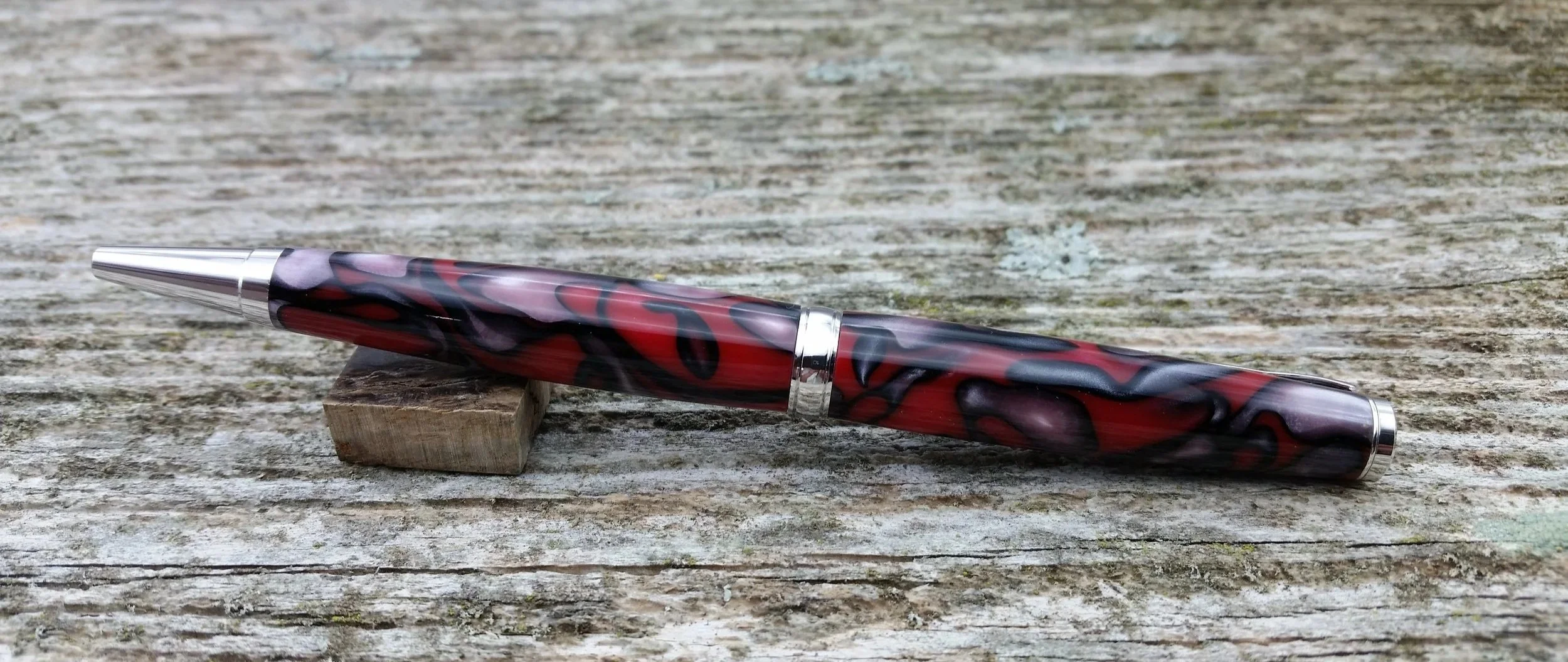 Parus Pen ballpoint twist pen with rhodium hardware and swirled red resin rear view