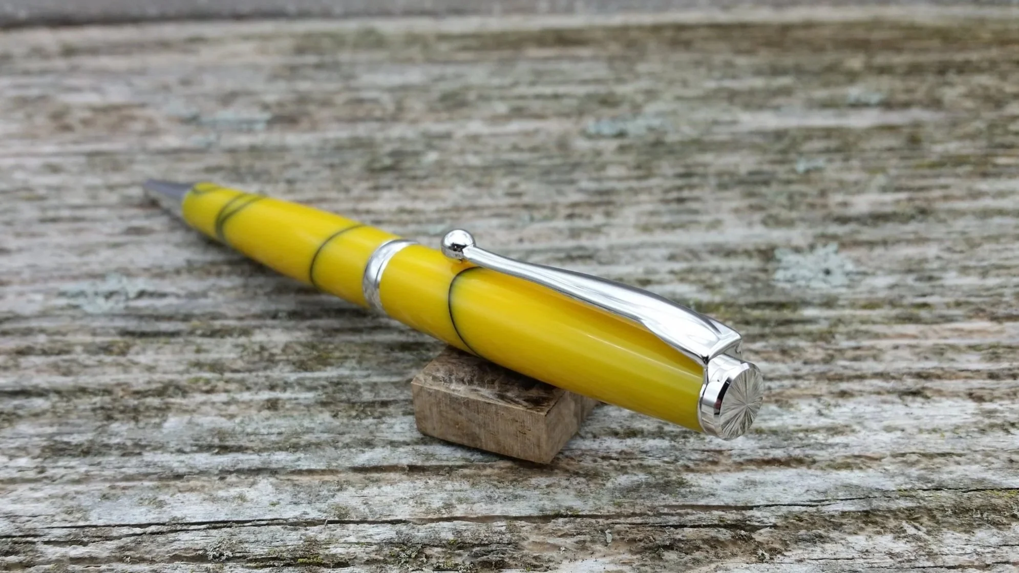 Parus Pen ballpoint twist pen with yellow resin and rhodium hardware end view