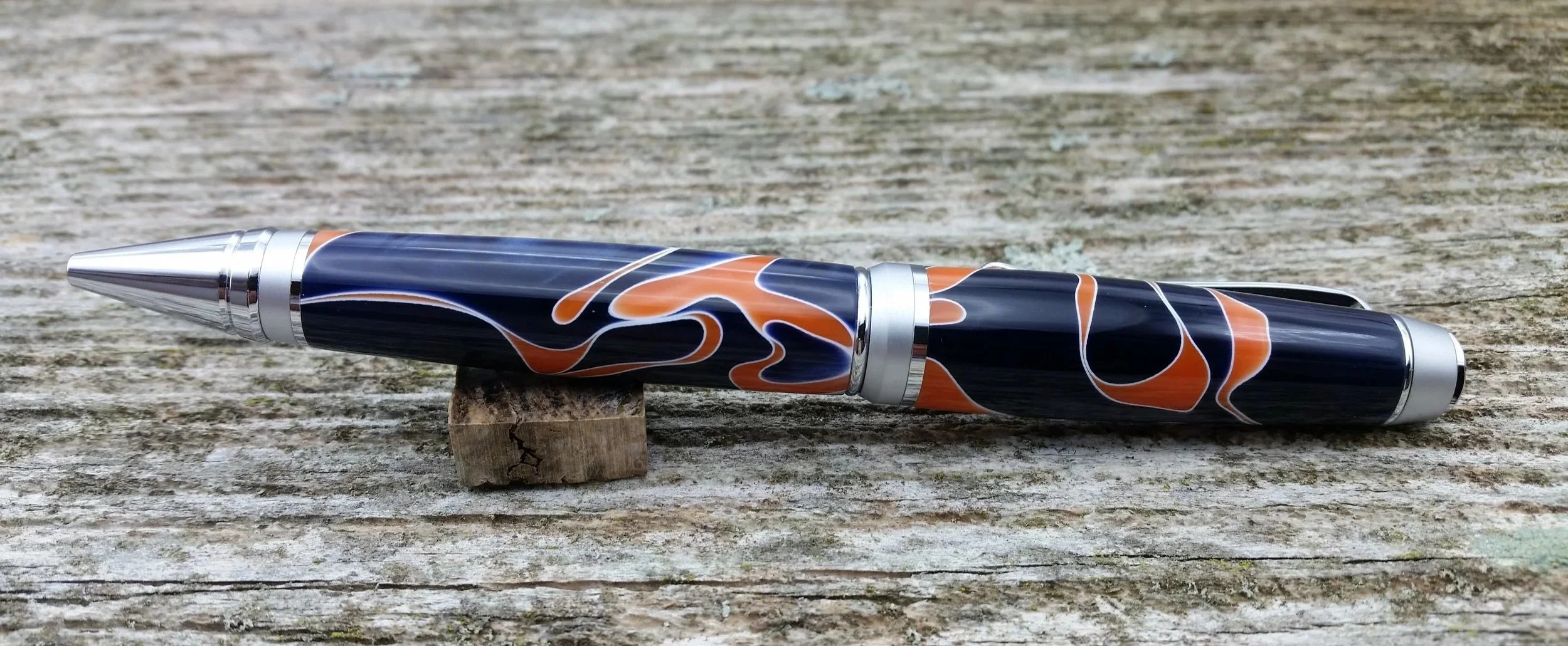 Parus Pen ballpoint twist pen with chrome hardware and blue, orange, white resin rear view