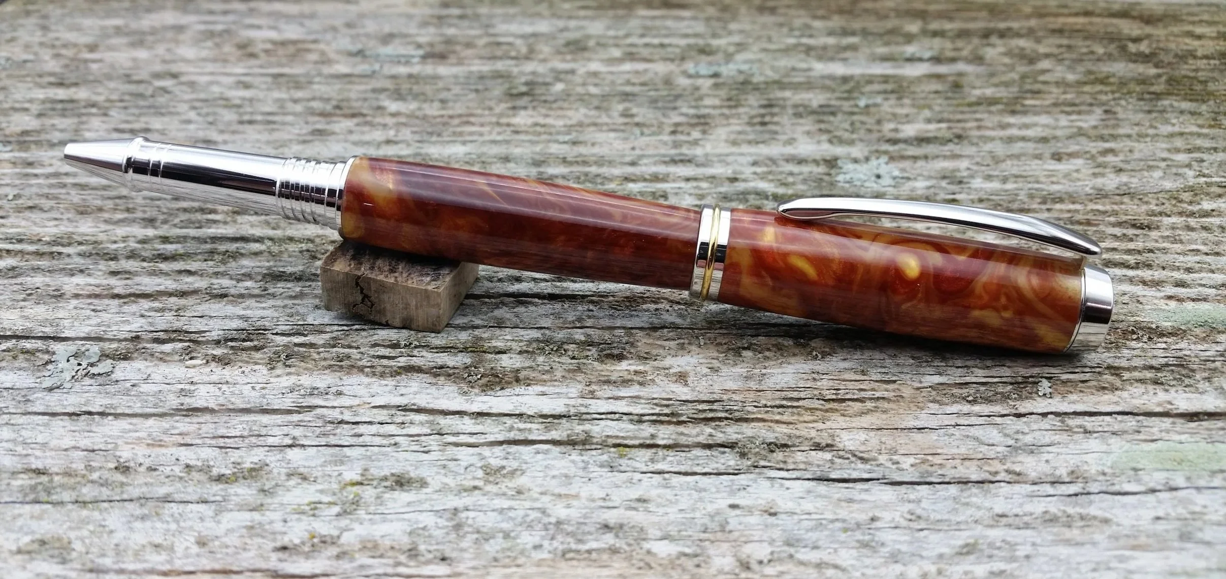 Parus Pen rollerball pen with rhodium and gold hardware and swirled amber resin posted view