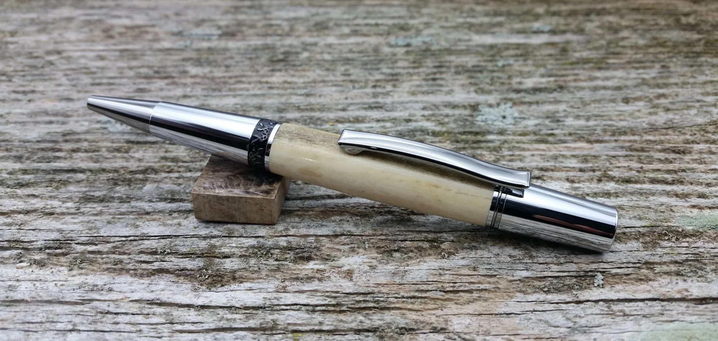 Parus Pen ballpoint twist pen with black titanium and chrome hardware and axis deer antler clip view
