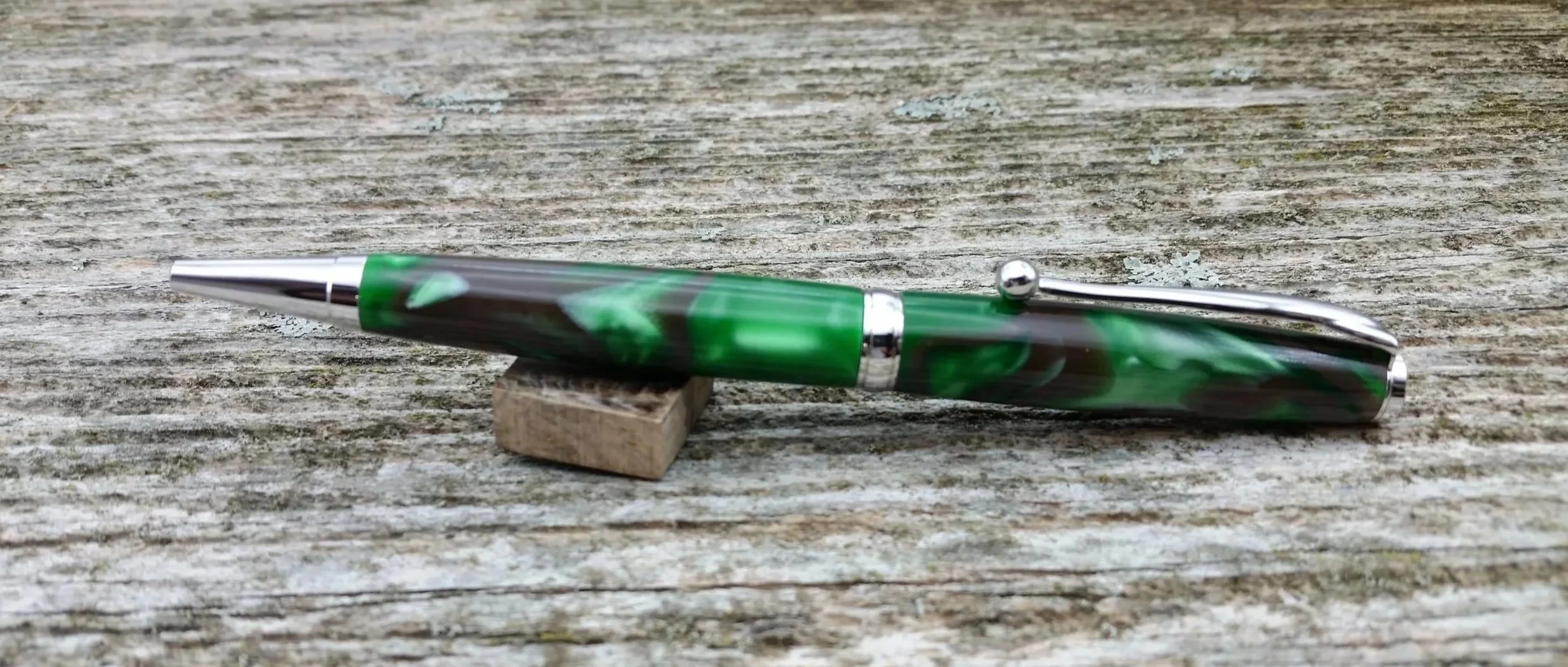 Parus Pen ballpoint twist pen with bright green and brown resin with rhodium hardware clip view