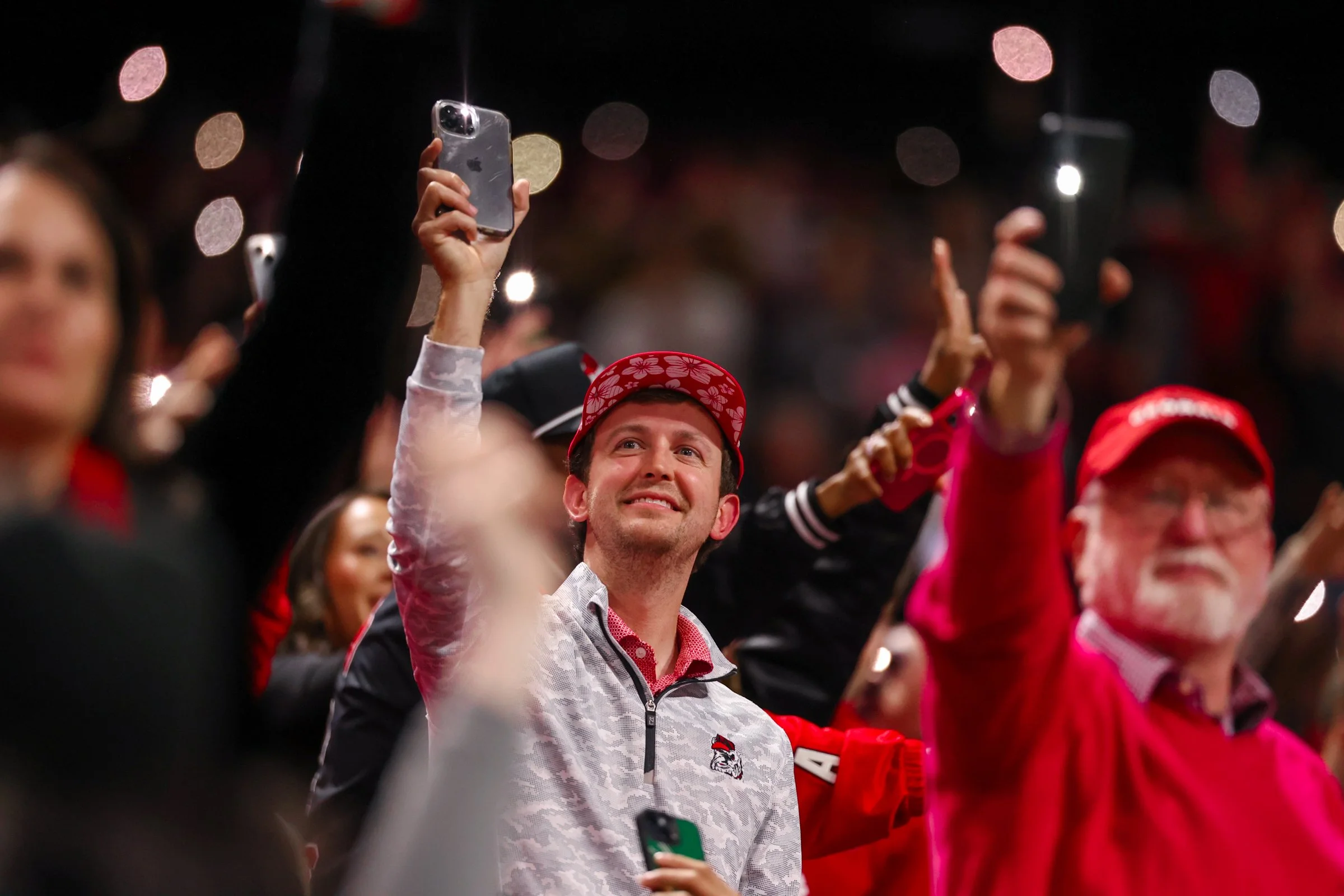 A Georgia fan holds up his phone at the start of the fourth quarter during the second half of the SEC Championship game between Georgia and Alabama at Mercedes-Benz Stadium in Atlanta, Georgia, on Saturday, Dec. 6, 2025. Georgia won 28-7. (Photo/Kale
