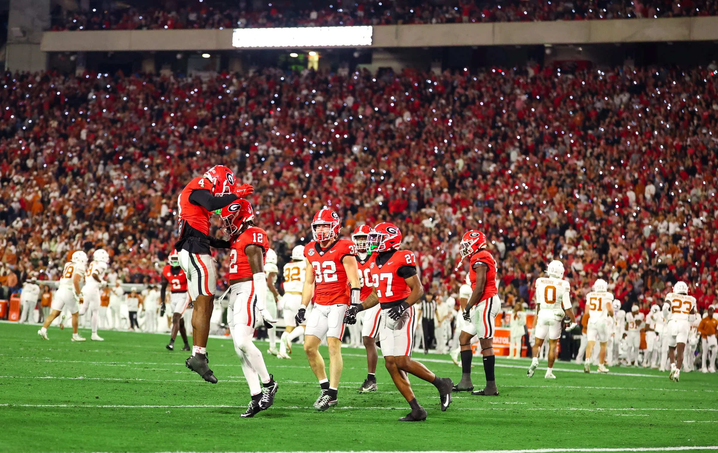 Georgia safety Jaden Harris (12) and Georgia defensive back K.J. Bolden (4) celebrate after a tackle during the second half of the football game between Georgia and Texas at Sanford Stadium in Athens, Georgia, on Saturday, Nov. 15, 2025. Georgia won 