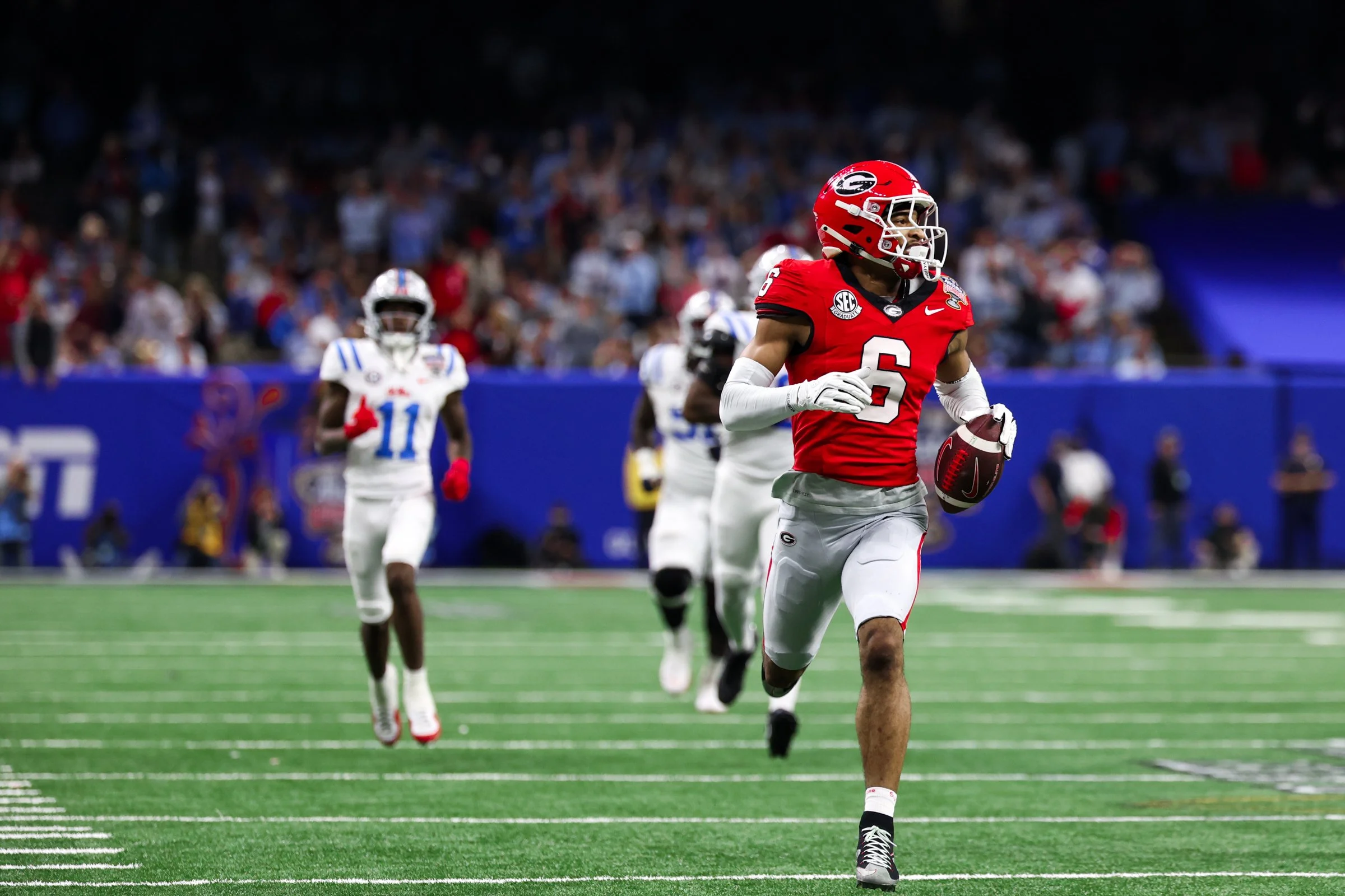 Georgia defensive back Daylen Everette (6) returns a fumble recovery for a touchdown during the first half of the 2026 Allstate Sugar Bowl College Football Playoff Quarterfinal game between Georgia and Ole Miss at the Caesars Superdome in New Orleans
