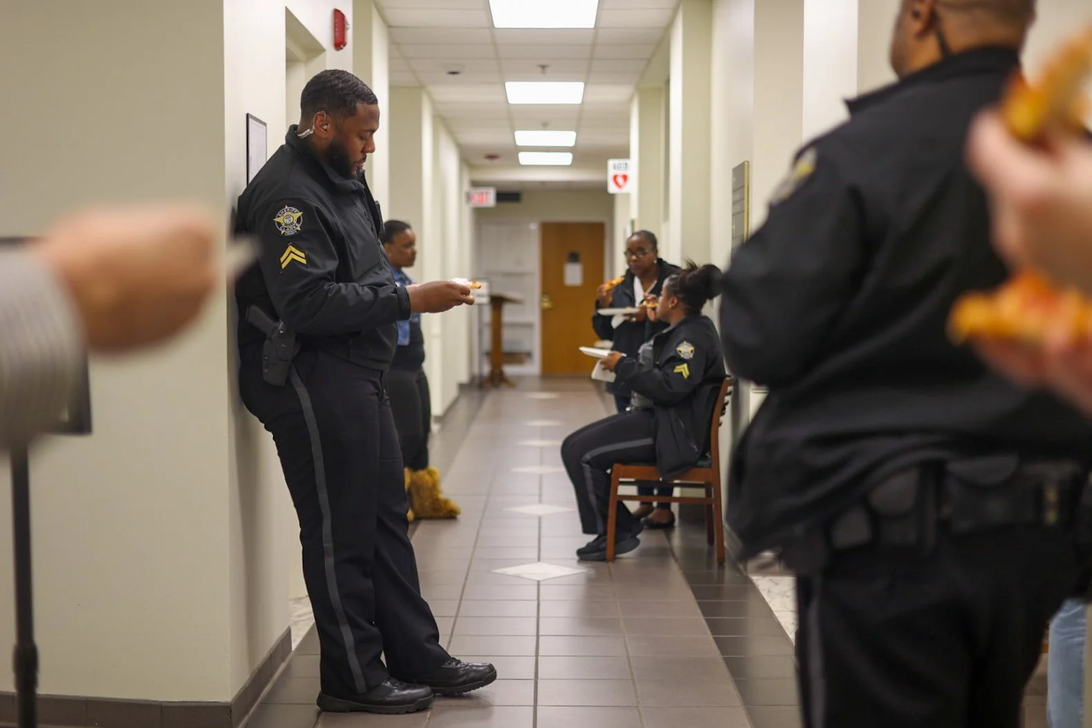 Athens-Clarke County court officers stand in a hallway eating pizza while waiting on a verdict during the Tara Baker murder trial at the Athens-Clarke County Courthouse in Athens, Georgia, on Monday, Feb. 16, 2026. (Photo/Kaleb Tatum)