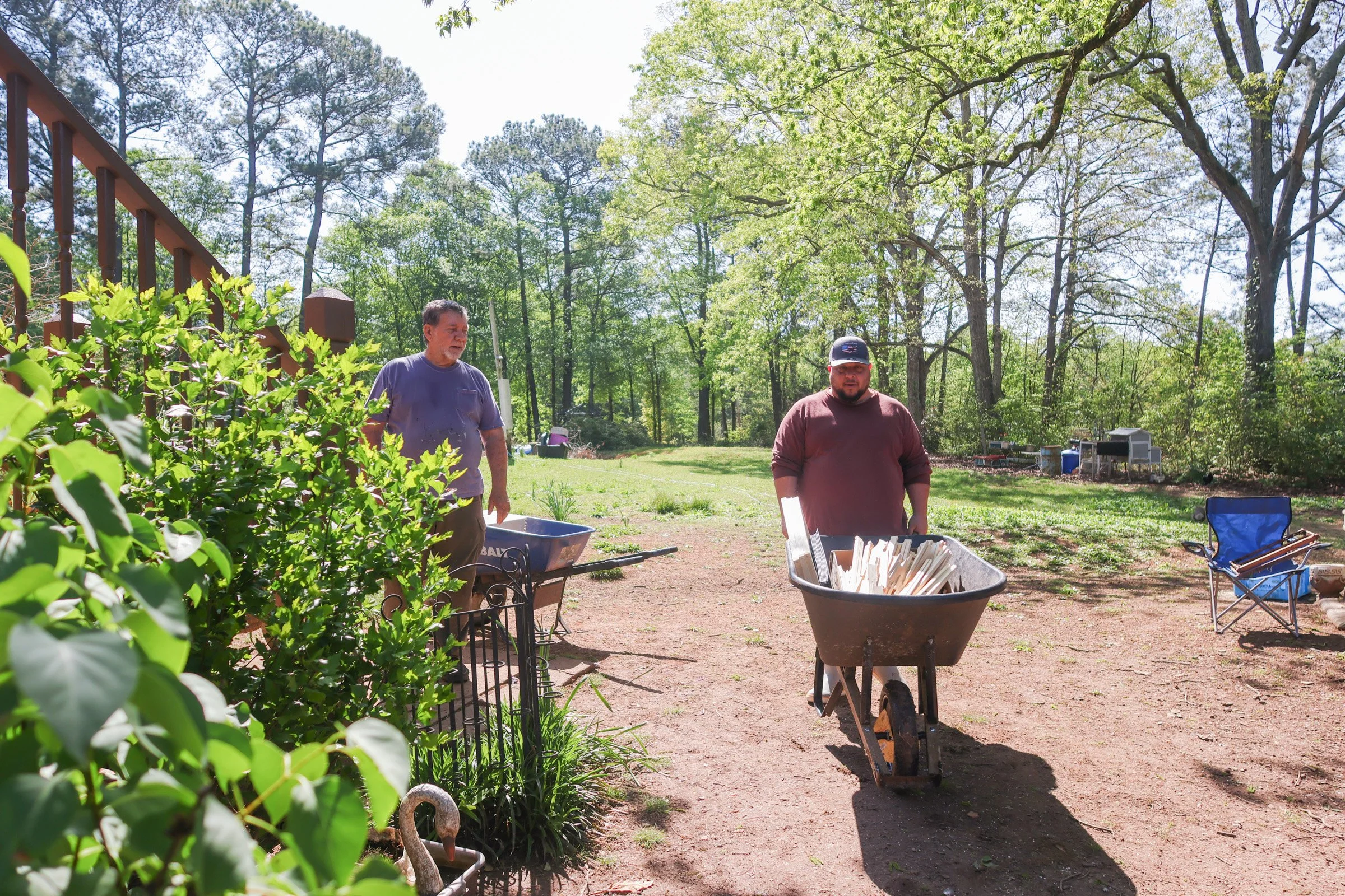 David Perez talks to Tom Hankins after buying beekeeper equipment in Danielsville, Georgia, on April 14, 2025. In addition to advising new beekeepers, Haskins also builds bee equipment to sell to newer beekeepers at lower prices.