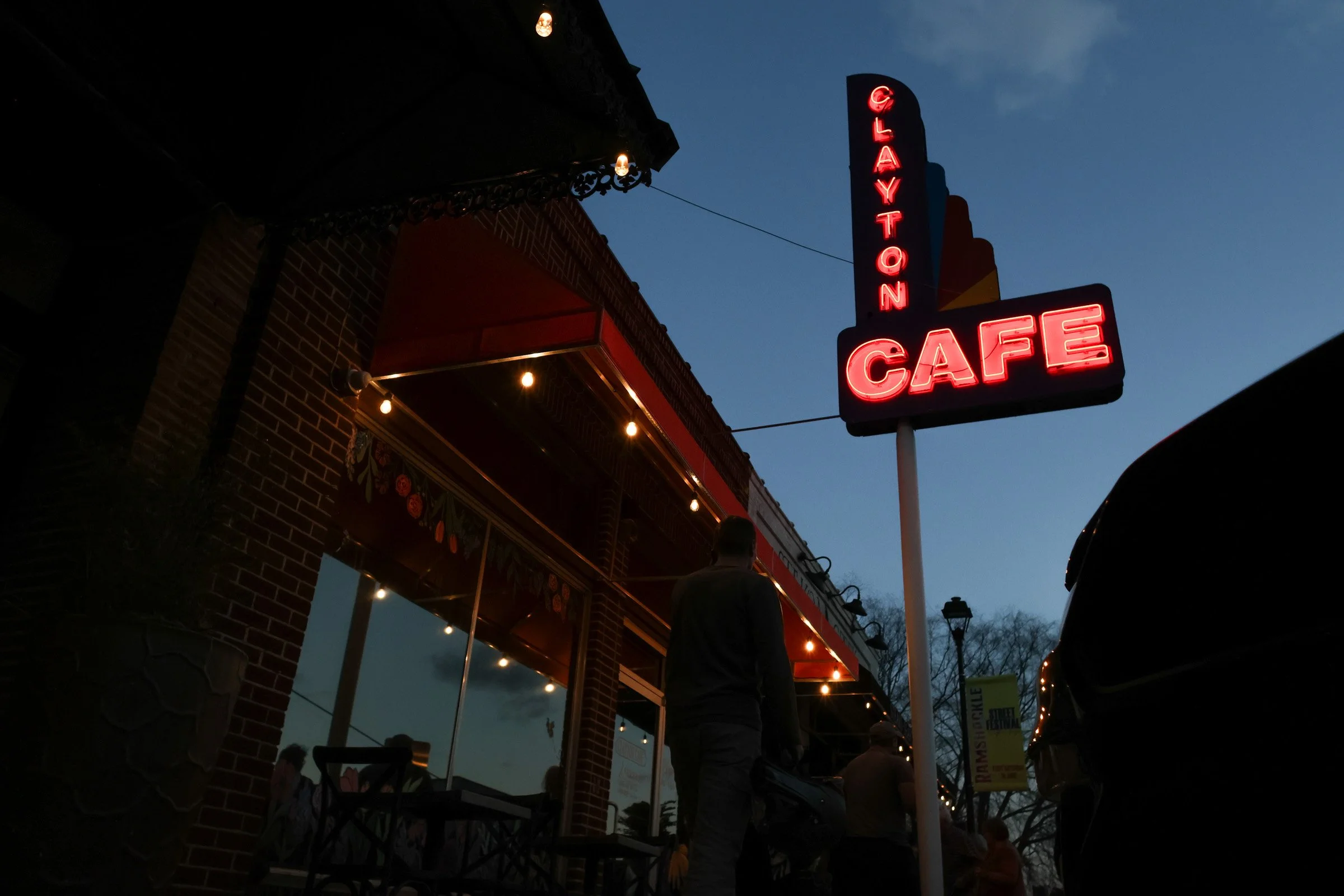 Clayton Cafe’s neon sign stands in downtown Clayton, Georgia on Mar. 14, 2025. Downtown Clayton consists of multiple local businesses such as coffee shops, art galleries, restaurants, and ice cream shops.(Photo/Kaleb Tatum)