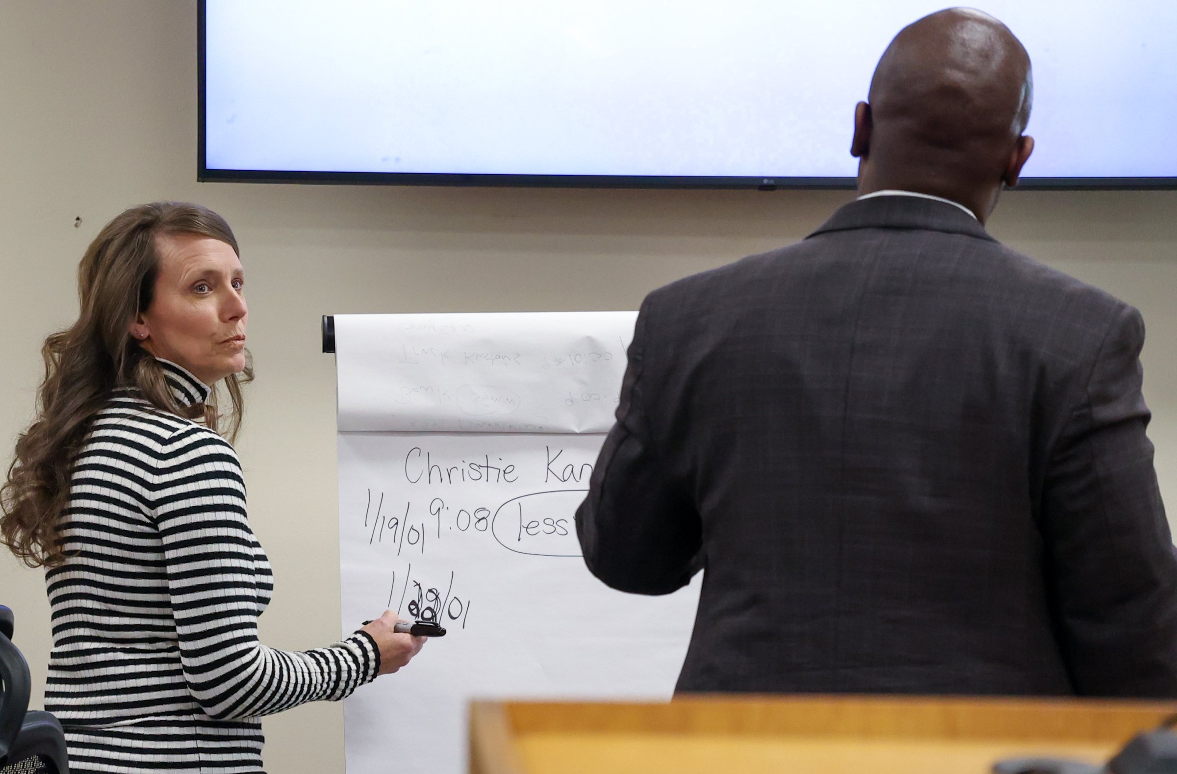 Christie Kane writes on paper while speaking with Defense Attorney Ahmad Crews during the Tara Baker murder trial at the Athens-Clarke County Courthouse in Athens, Georgia, on Monday, Feb. 9, 2026.  (Photo/Kaleb Tatum)