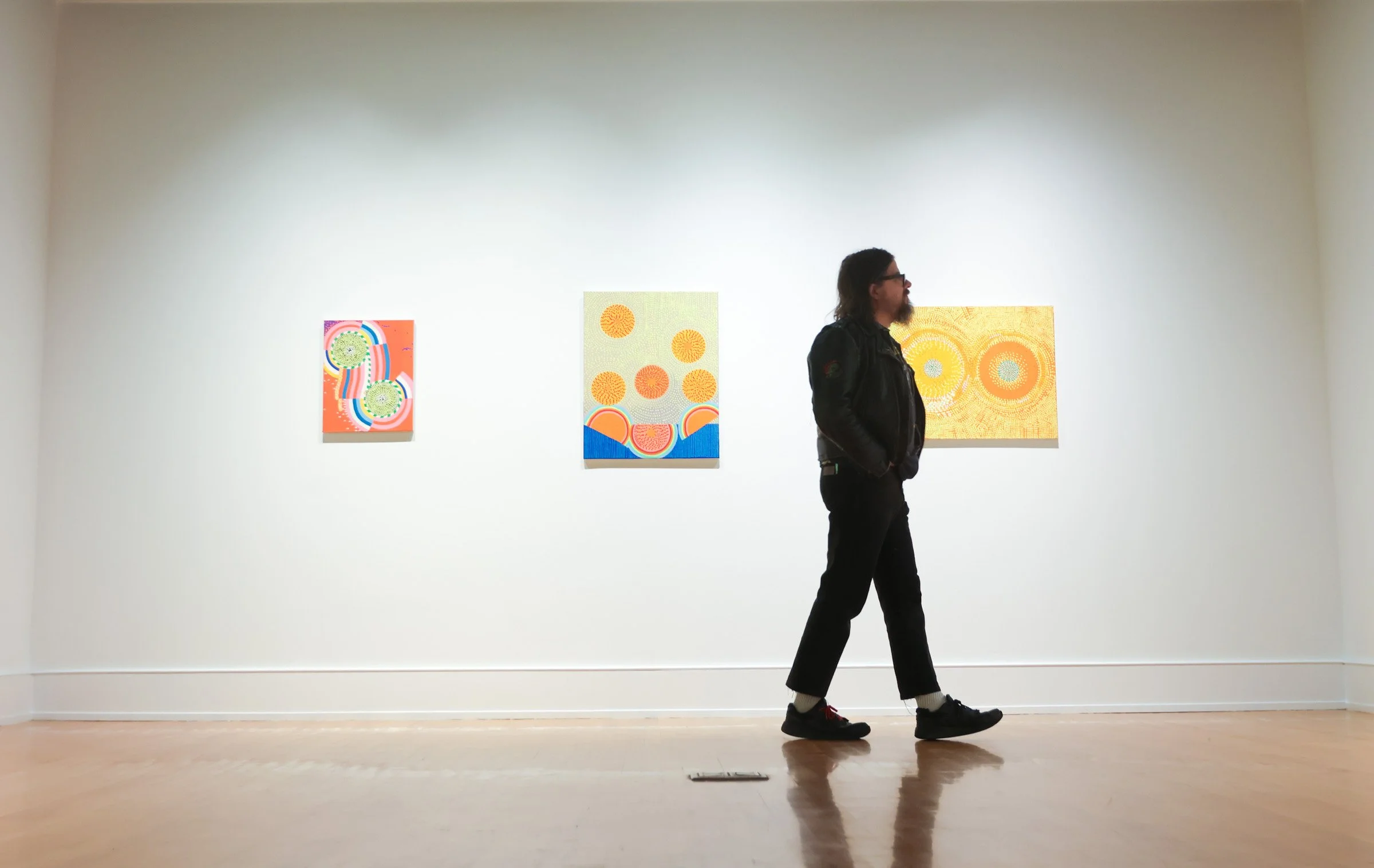 Artist Tim Root looks at artwork created by Carol John during the Lyndon House Arts Center artist reception in the Lyndon House Arts Center in Athens, Georgia, on Thursday, Jan. 16, 2024. The Lyndon House Arts Center artist reception celebrated the o
