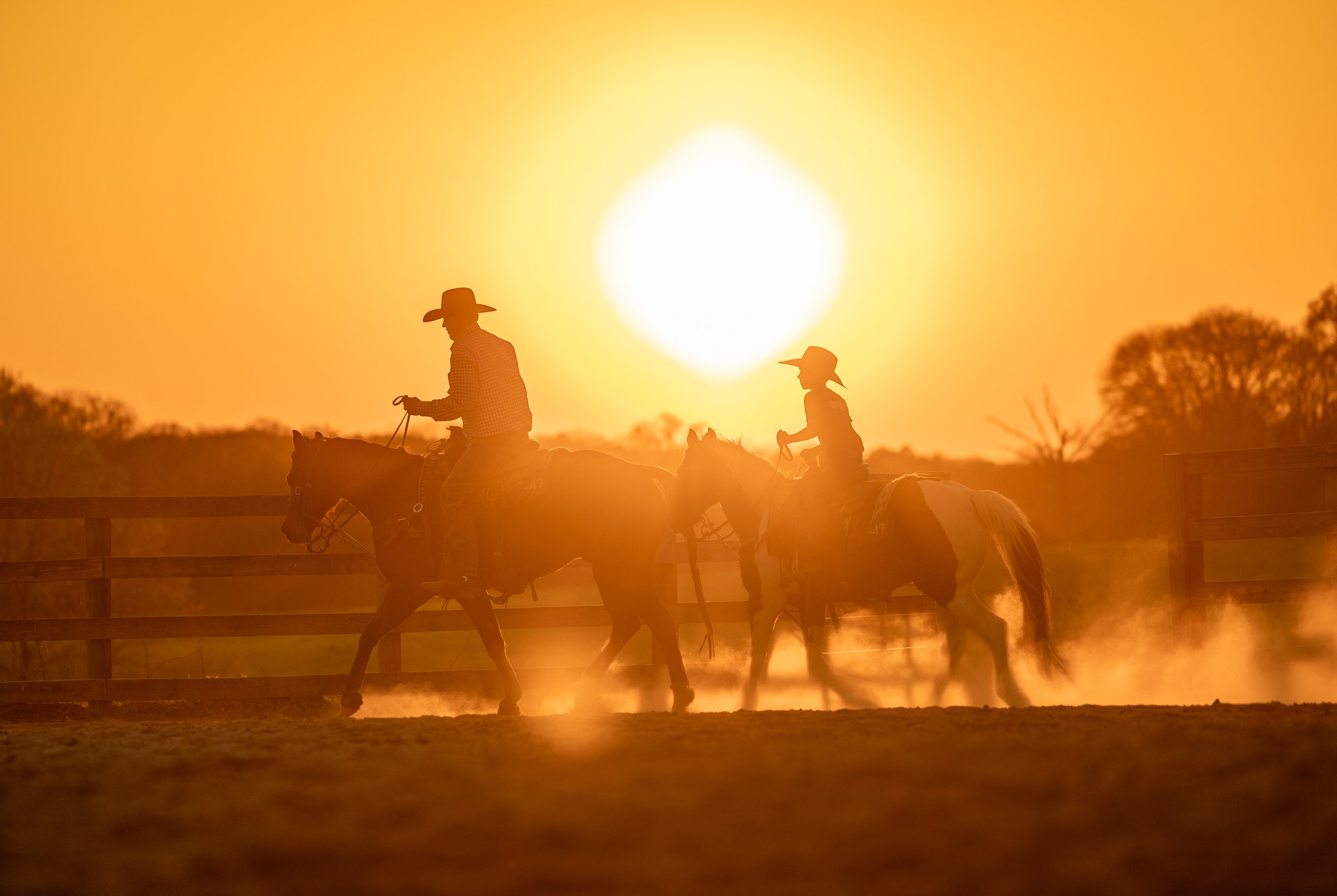 A father and his son ride their horses during the Great Southland Stampede Rodeo outside of the University of Georgia Livestock Instructional Arena in Athens, Georgia, on Saturday, March 21, 2026. This year marks the 51st anniversary of the rodeo. (P
