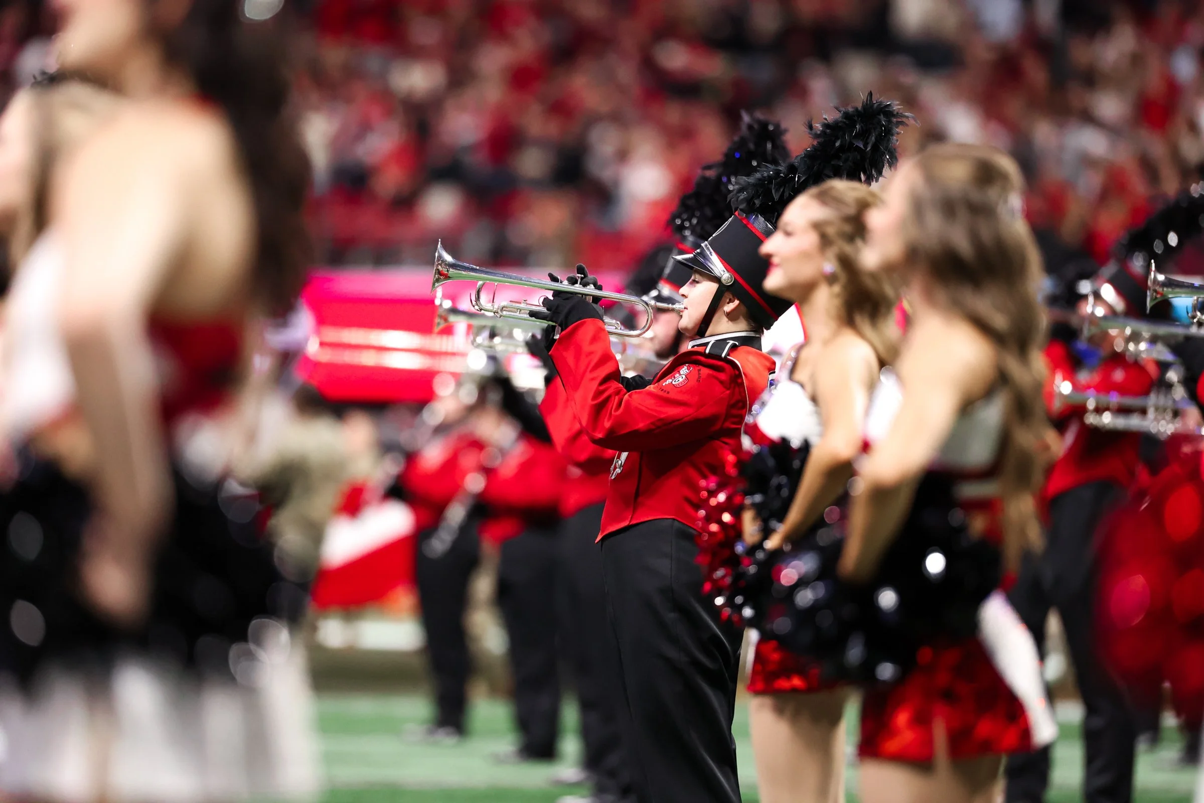 Members of the Redcoat Marching Band perform on the field before the SEC Championship game between Georgia and Alabama at Mercedes-Benz Stadium in Atlanta, Georgia, on Saturday, Dec. 6, 2025. Georgia leads 14-0. (Photo/Kaleb Tatum)