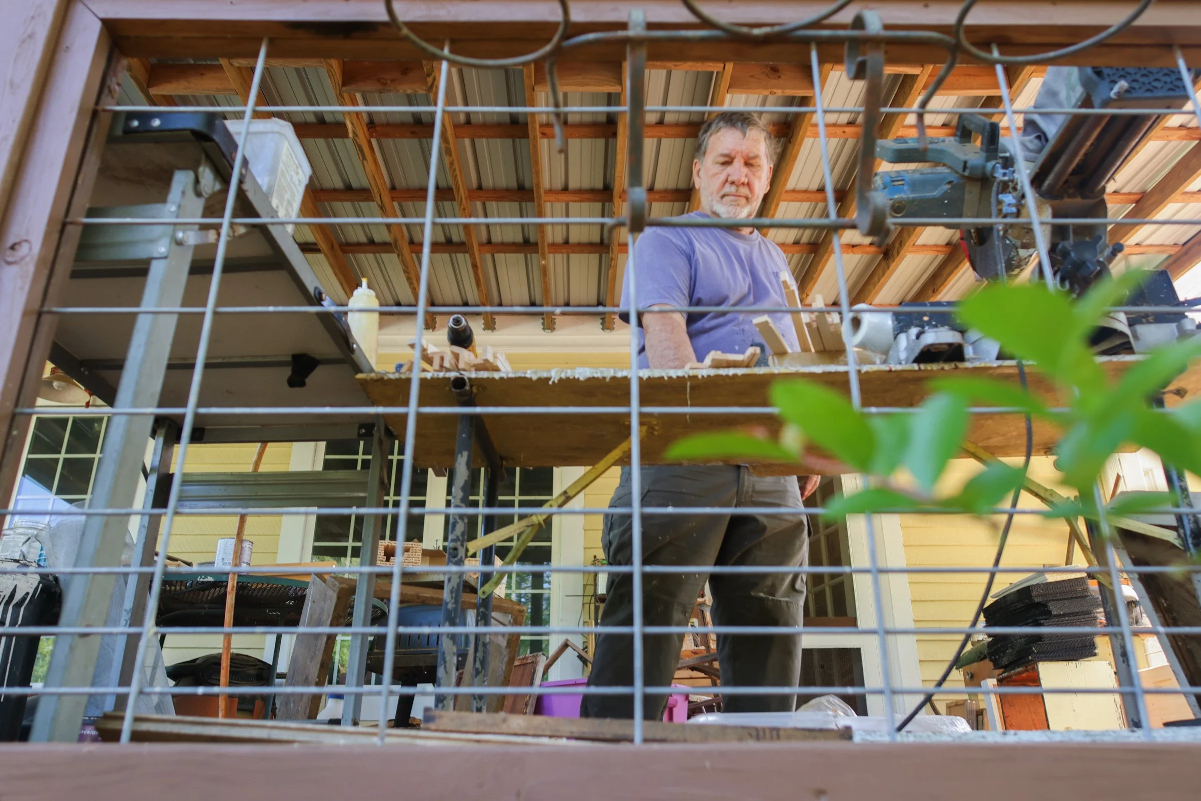Tom Hankins builds beekeeping equipment on his back porch in Danielsville, Georgia, on April 14, 2025. In addition to advising new beekeepers, Haskins also builds bee equipment to sell to newer beekeepers at lower prices. 