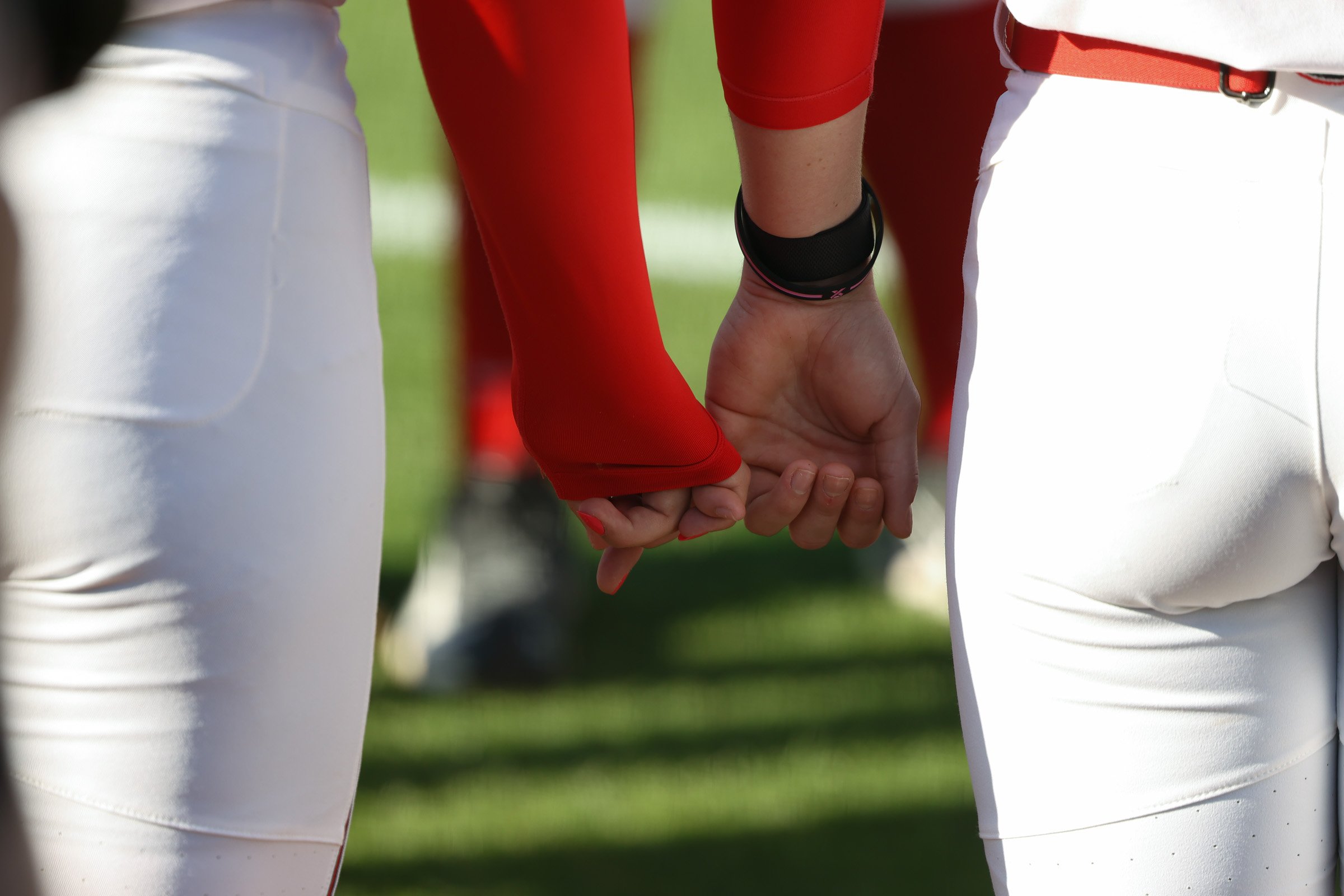 Teammates hold hands before prayer during the Georgia vs. USC Upstate softball game at Jack Turner Stadium in Athens, Georgia, on Wednesday, April 9, 2025. The 16th-ranked Georgia Bulldogs defeated the USC Upstate Spartans 3-2 on Wednesday in the nin