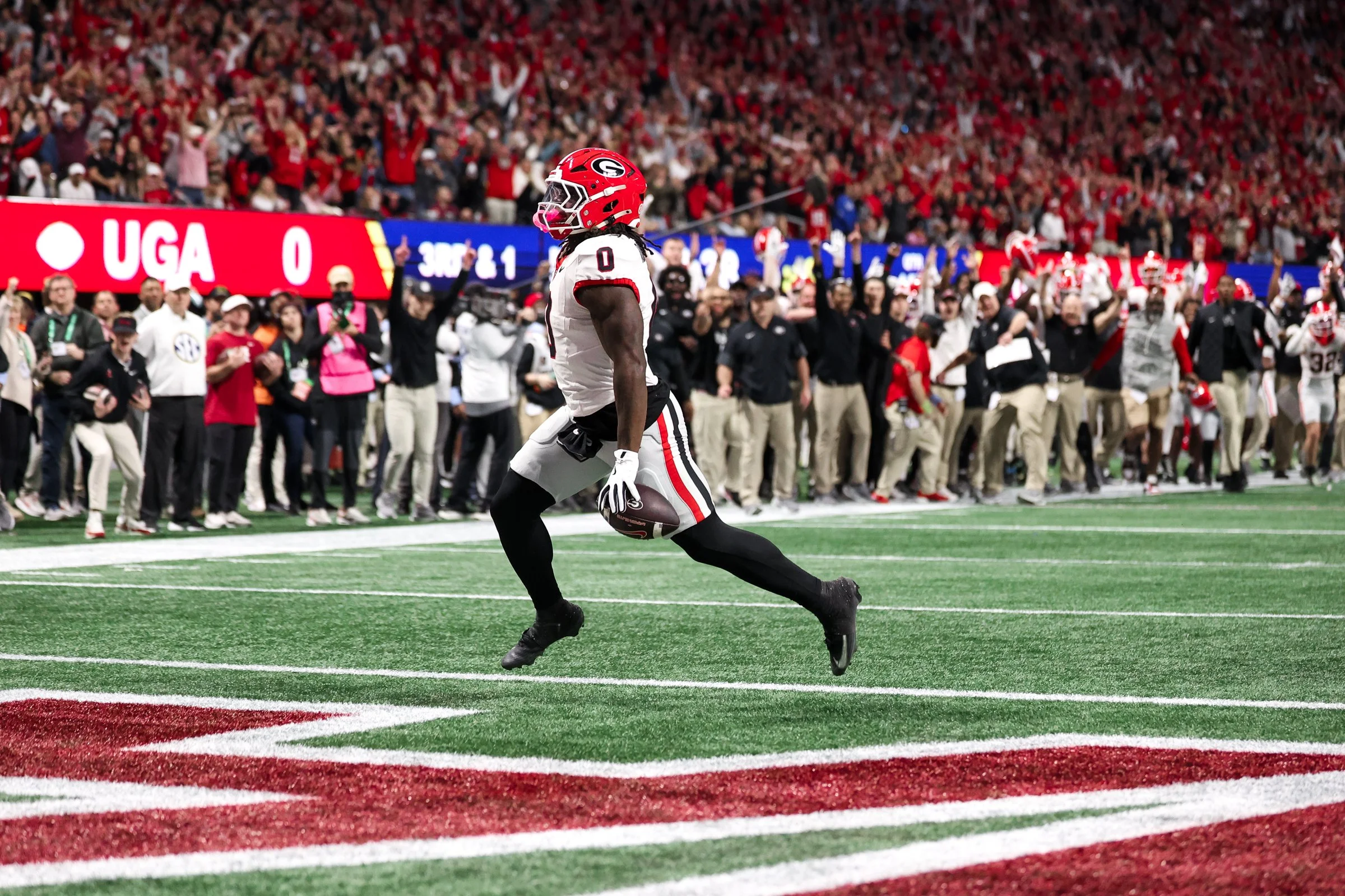 Georgia running back Roderick Robinson II (0) runs in for a touchdown during the first half of the SEC Championship game between Georgia and Alabama at Mercedes-Benz Stadium in Atlanta, Georgia, on Saturday, Dec. 6, 2025. Georgia leads 14-0. (Photo/K