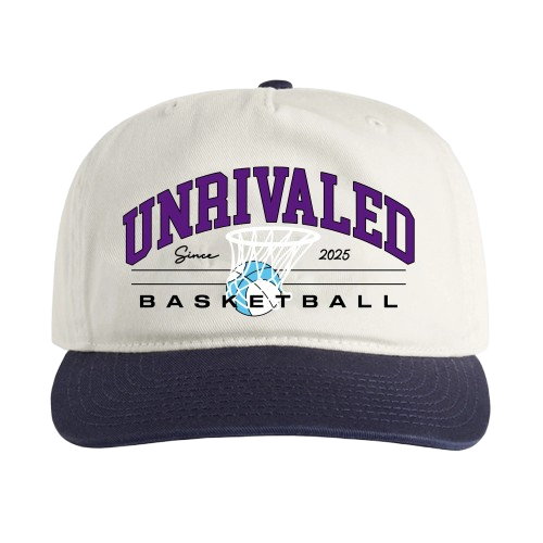 White and navy baseball cap with purple and black text that reads "UNRIVALED Basketball 2025" and features a stylized basketball hoop with a ball going through it.