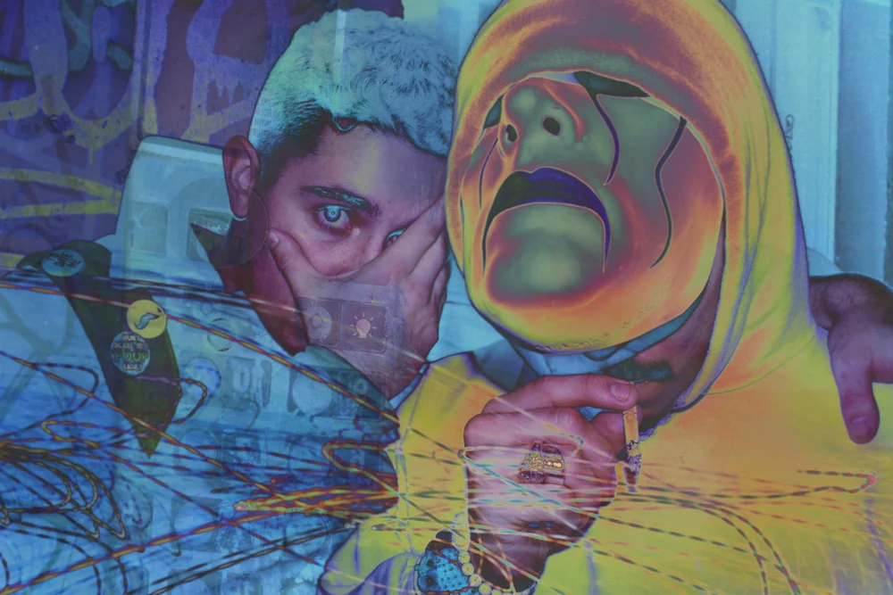 Color-shifted multiple exposure of two people, one in a yellow hoodie and painted mask.