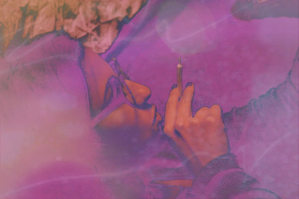 Pink-toned image of a person's face and a hand holding a cigarette.