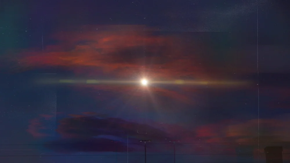 A bright point of light in a dark sky streaked with thin red clouds.