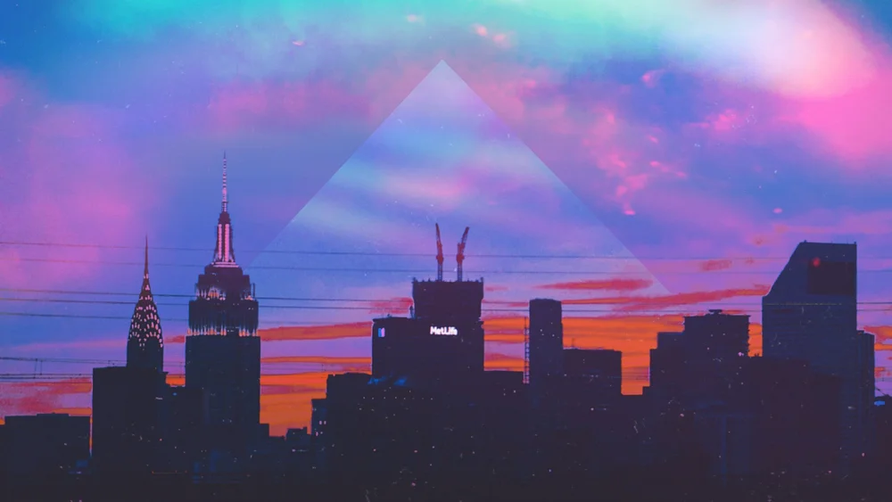 A city skyline in silhouette under a pink and blue sky, with a faint triangle overlay.