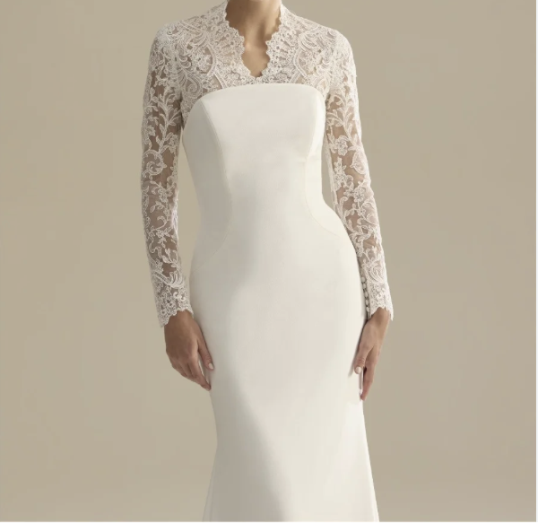 Elegant white wedding dress with lace long sleeves and a lace neckline on a mannequin