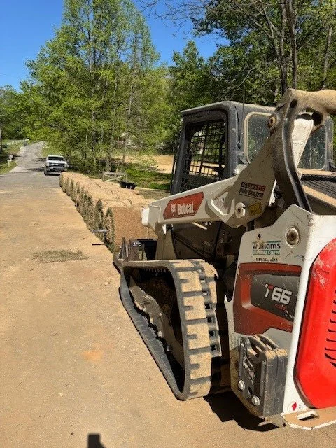 A skidsteer with sod lined up for a sod installation project in Bartlett Tennessee.