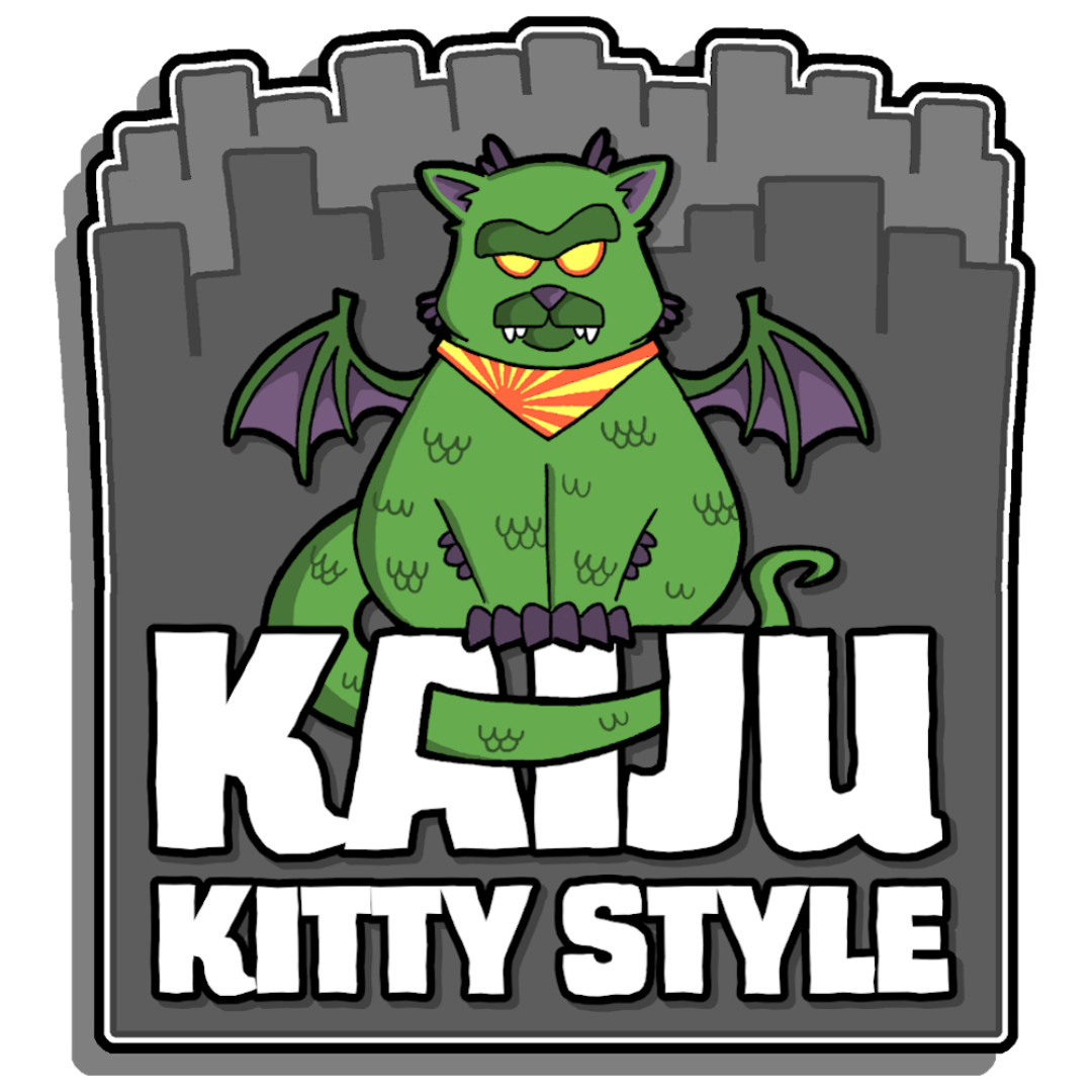 A cartoon green dog with wings, fangs, and an angry expression, sitting in front of a city skyline. The dog is wearing an orange and yellow striped bandana, and there is a large text below it that reads "KAJU" and "KITTY STYLE."