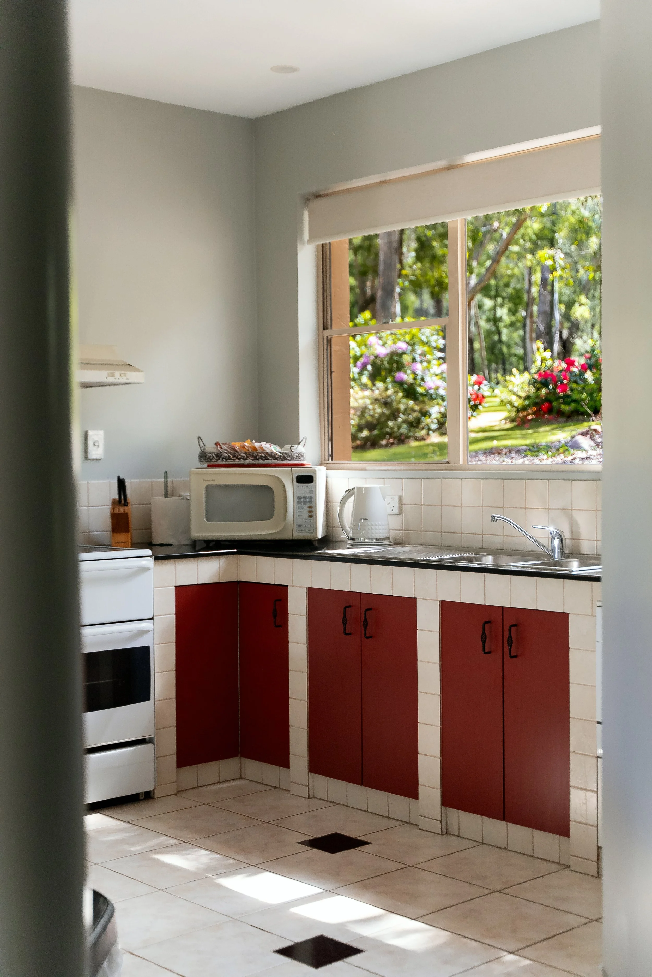 Kitchen with a window overlooking a garden with flowers