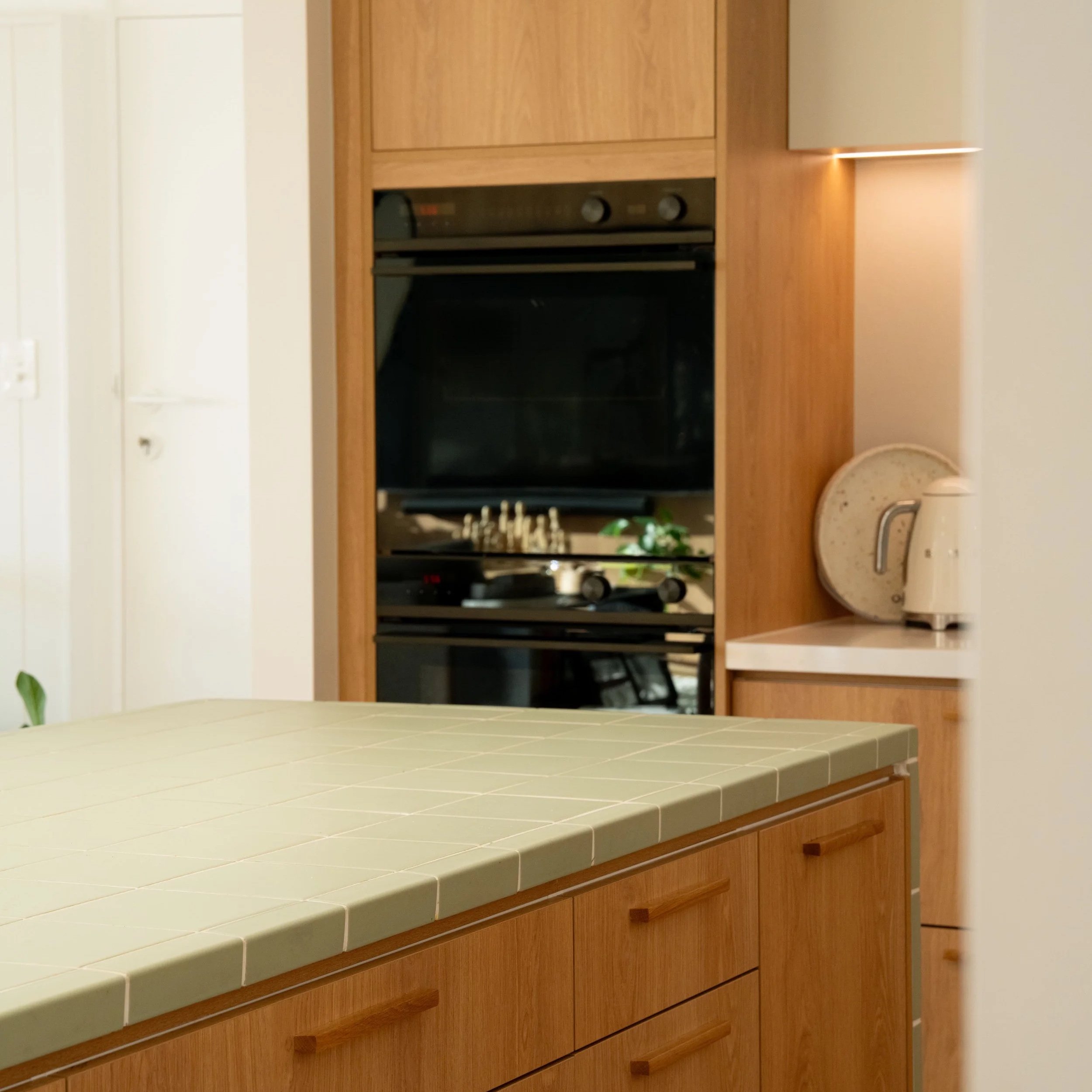 Custom kitchen cabinetry with integrated oven in Seacliff