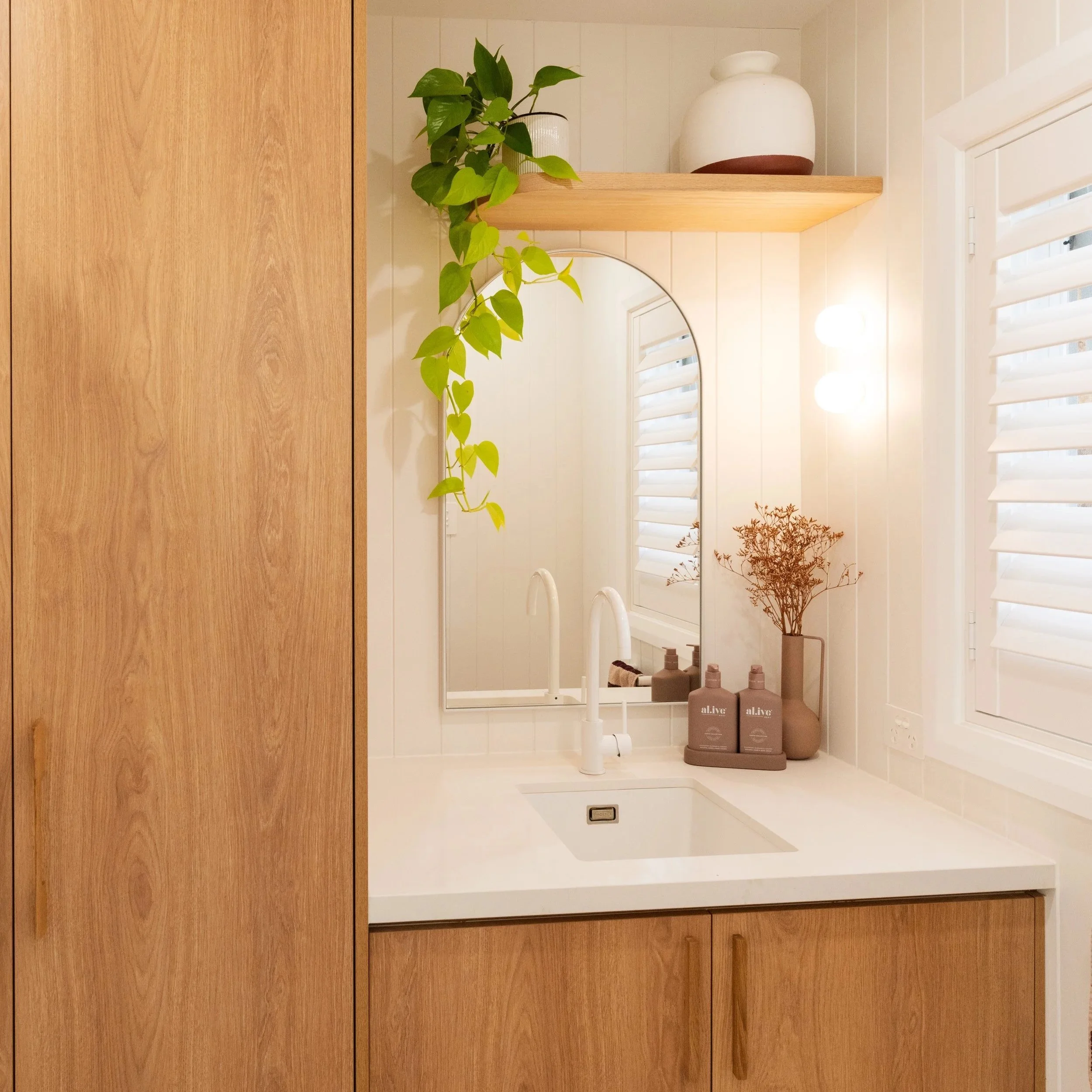 Timber bathroom vanity with round mirror in Seacliff