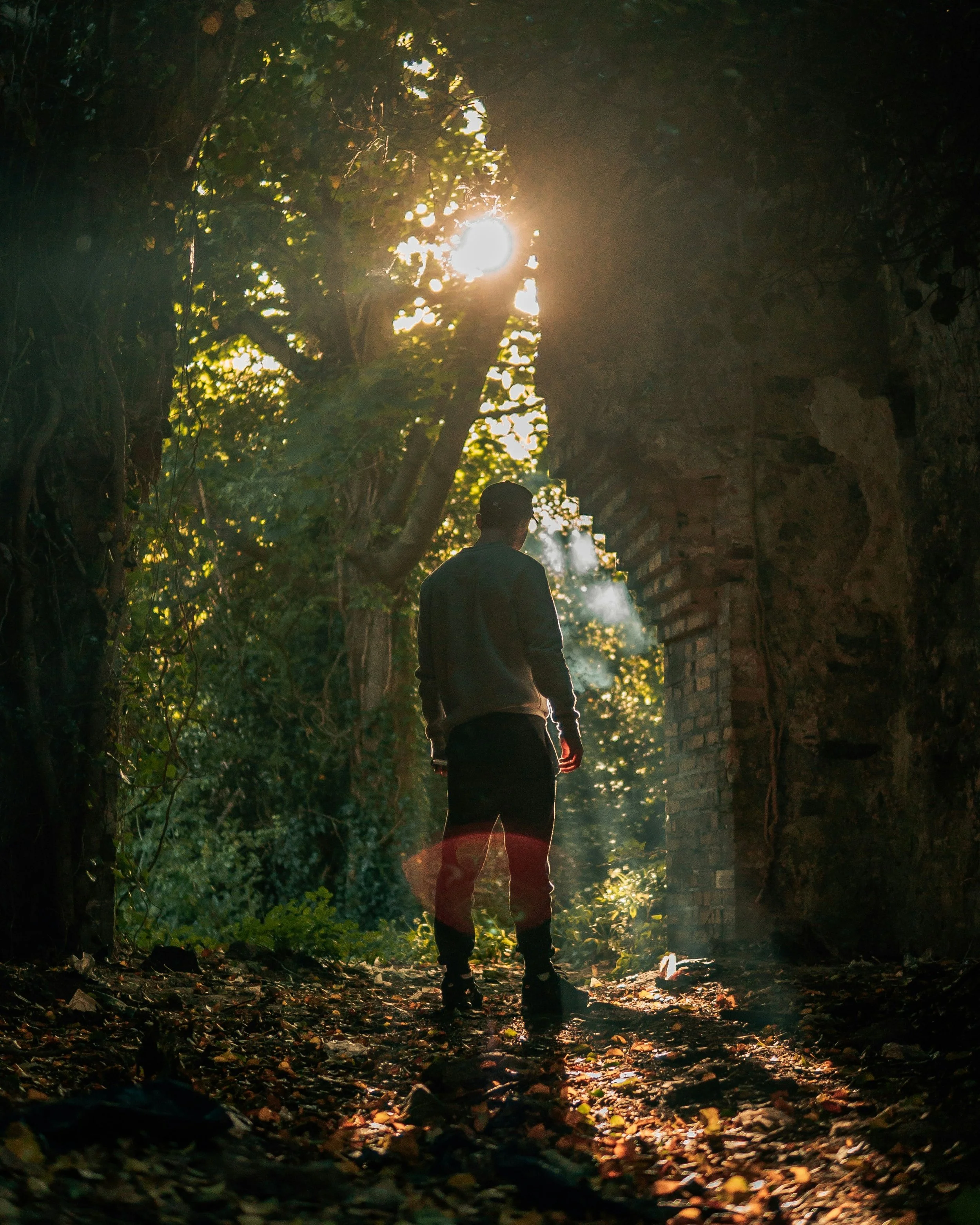 Man standing in the woods on a hike alone