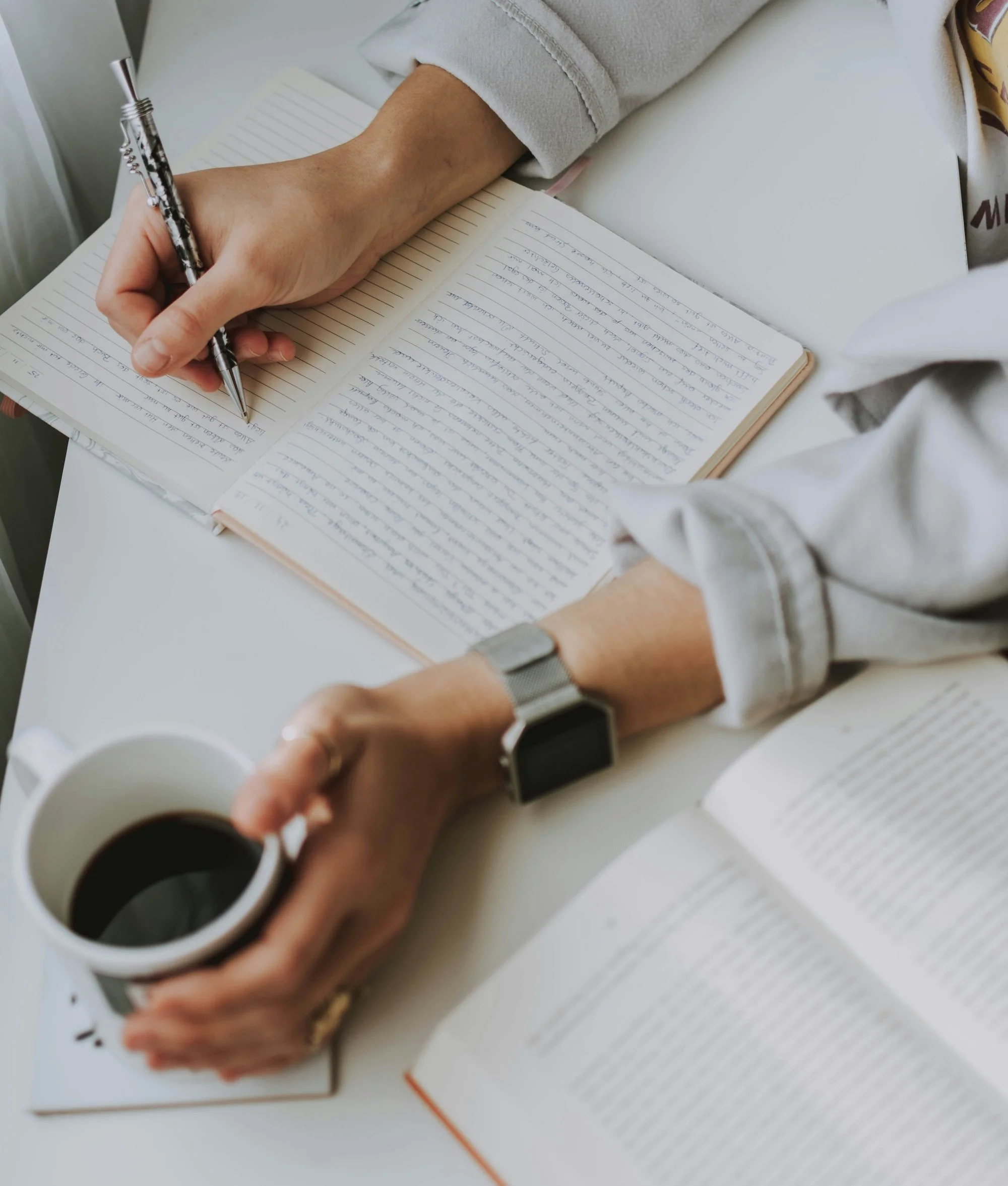 Woman organizing thoughts writing in a notebook
