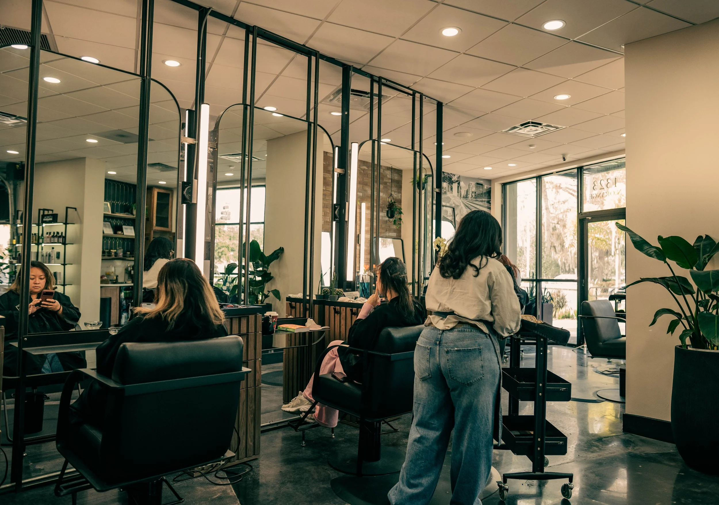 The expert styling team at Très Ivanhoe Salon in Orlando providing full-service hair and nail care, demonstrating the convenient one-stop luxury experience praised by our clients.
