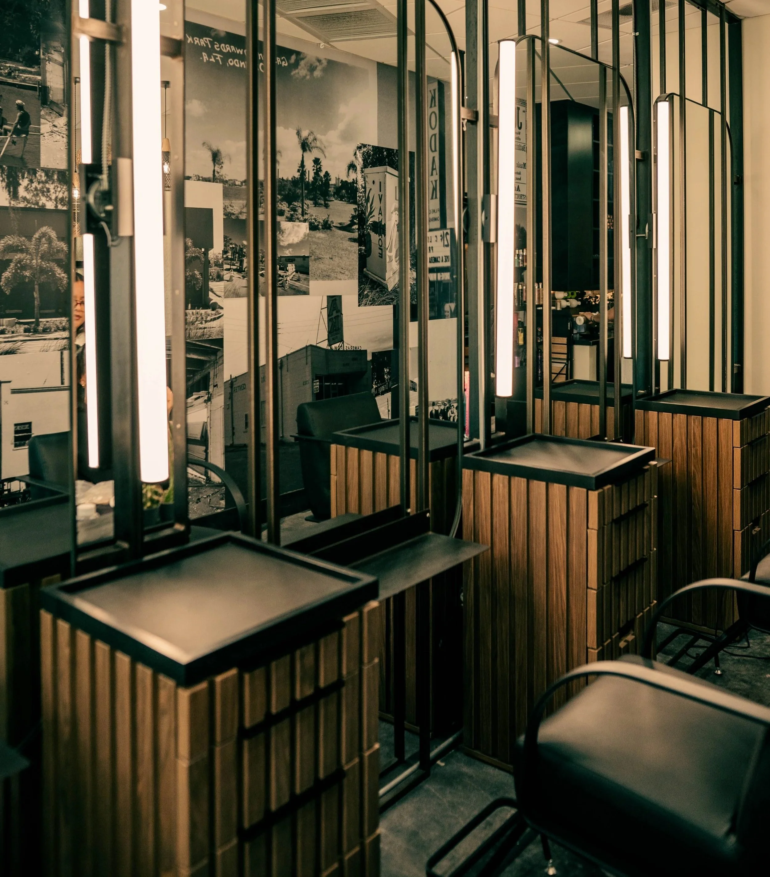 The dedicated Hair Artistry stations at Très Ivanhoe Salon in Orlando, featuring modern wooden cabinetry, professional lighting, and a luxurious atmosphere for precision cuts and color.
