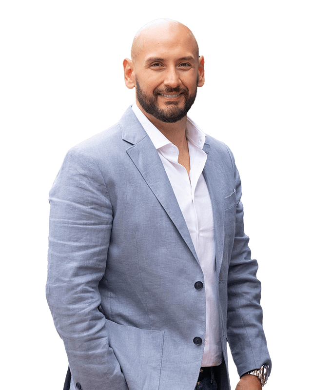 Marcos Torres, leadership advisor and keynote speaker, wearing a light blue blazer over a white shirt.