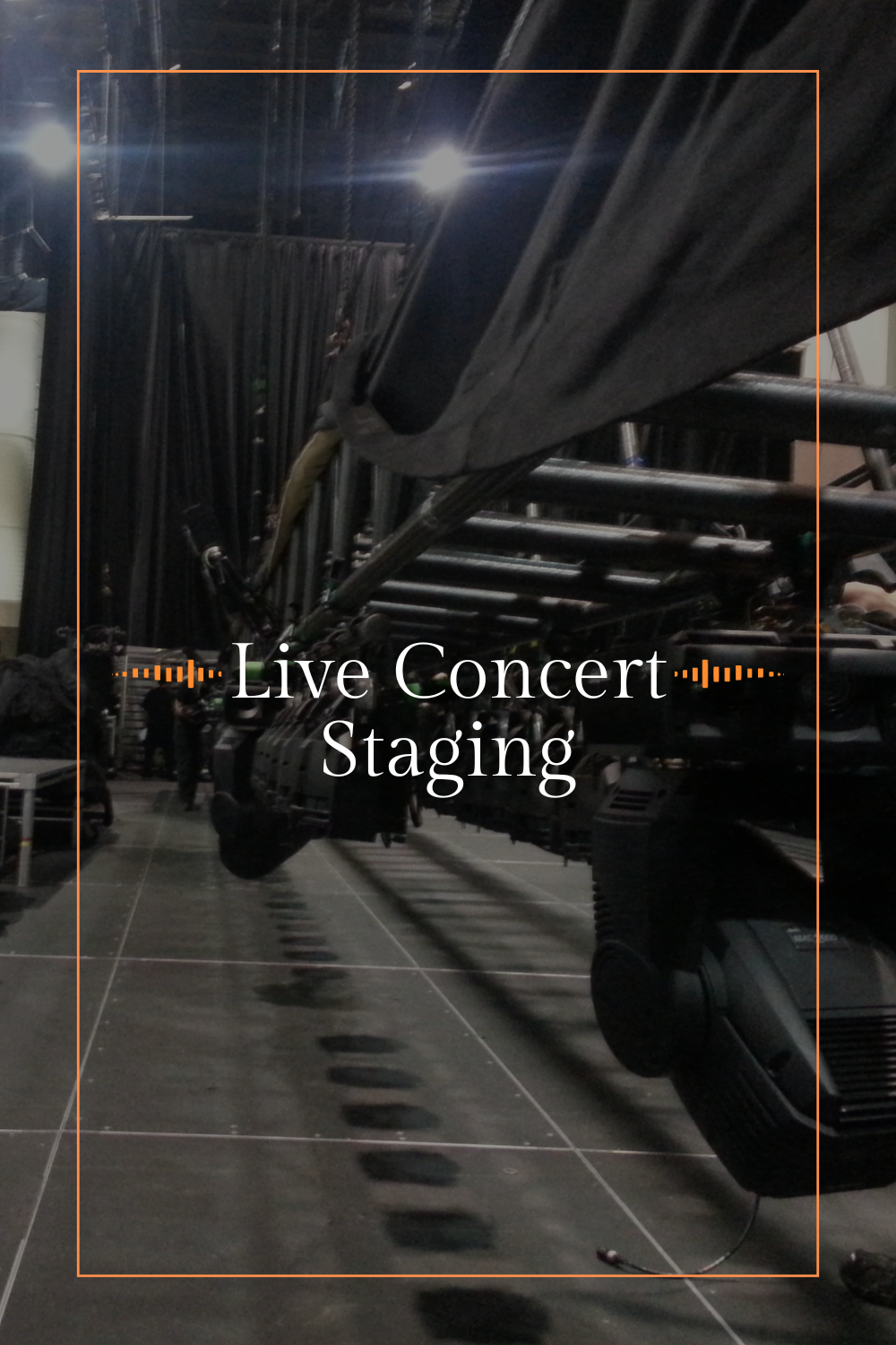 Stage scaffolding in a large indoor venue with lighting and equipment for a live concert