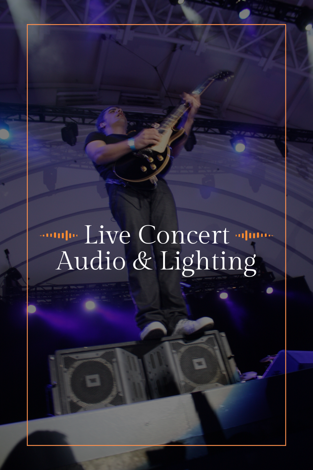 A musician playing an electric guitar on stage during a live concert with lighting effects and a sound system.