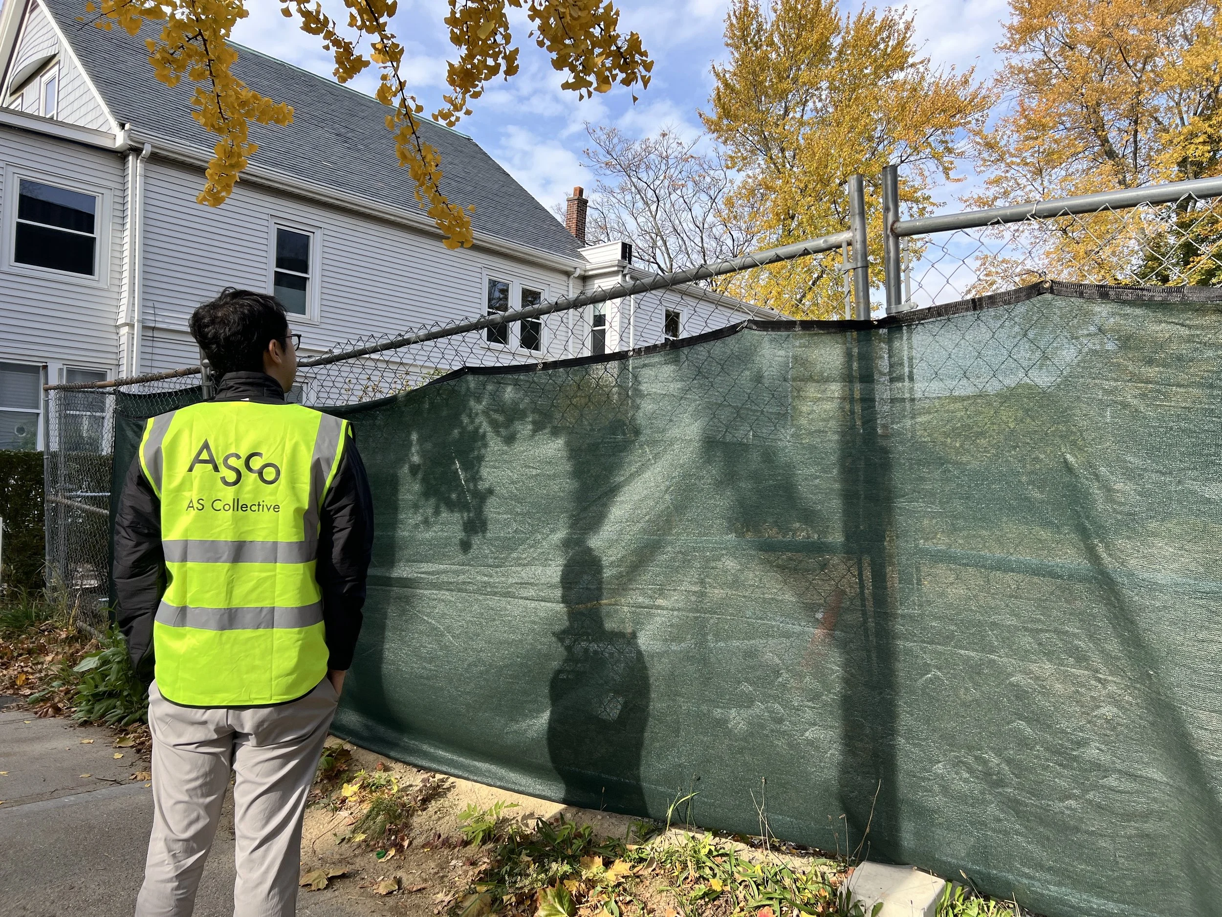 A person wearing a yellow safety vest with