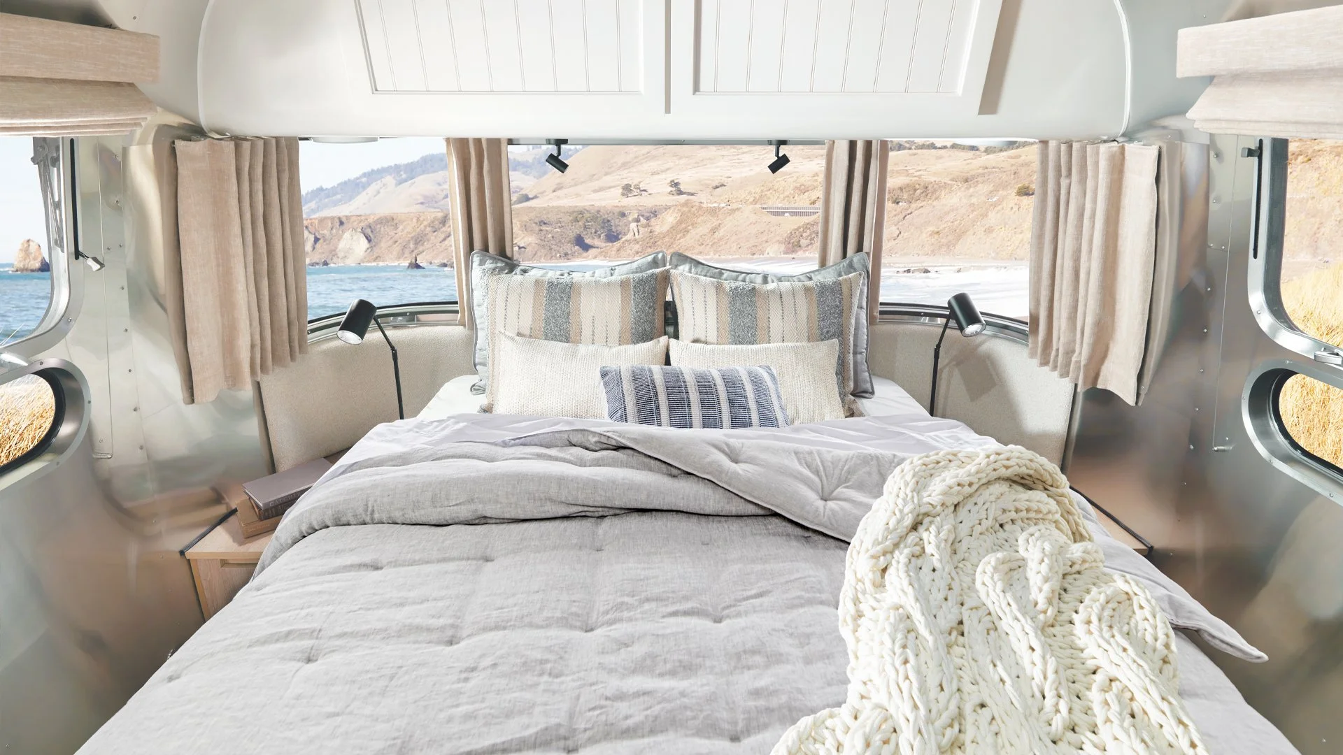 Picture of an expertly made bed in the sleeping area in an Airstream RV, Pottery Barn Edition.