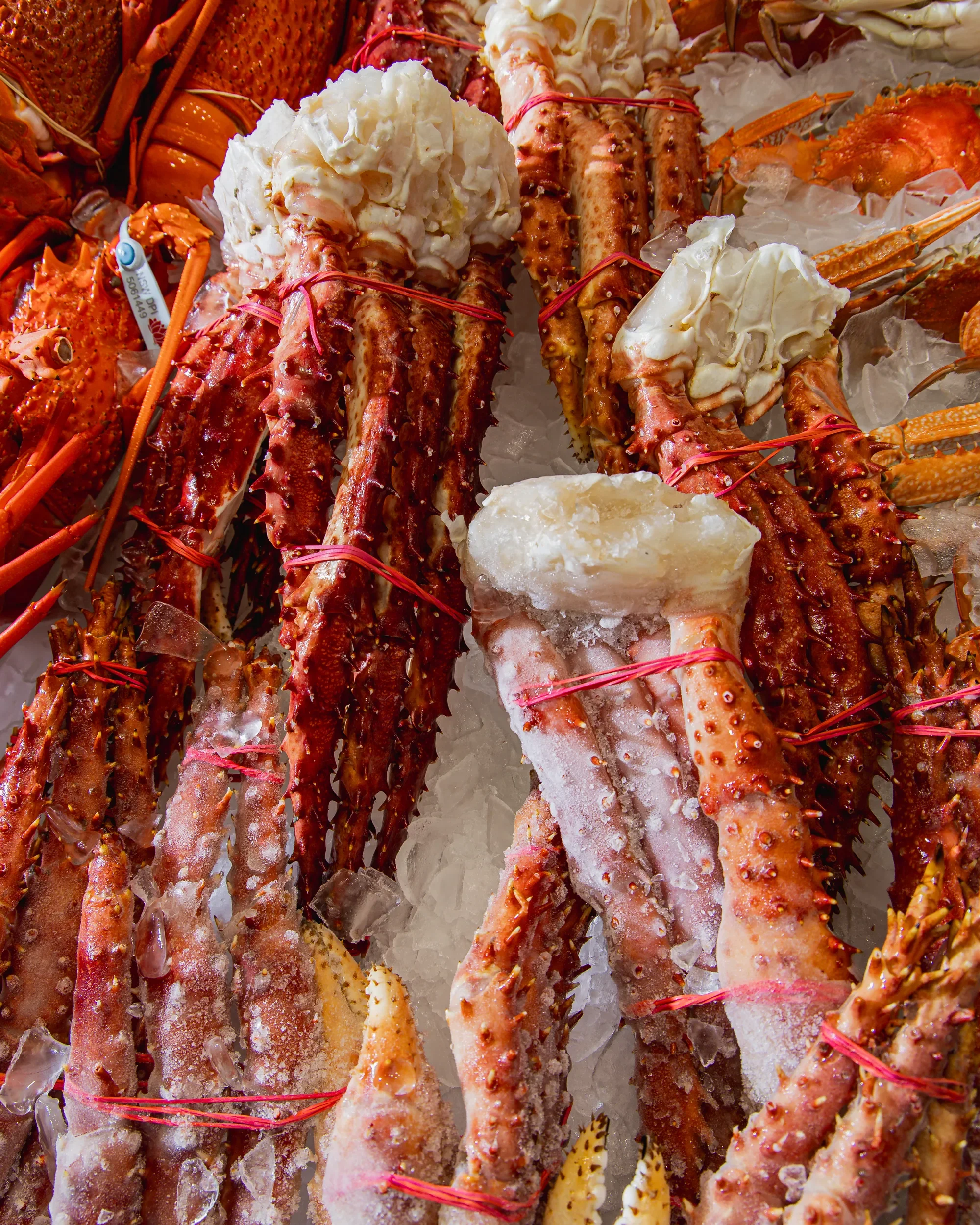 Fresh lobsters on ice at a seafood market.