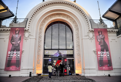 Entrance to a building with two vertical banners of David Bowie on either side, advertising 'Bowie by Rock Buenos Aires.'