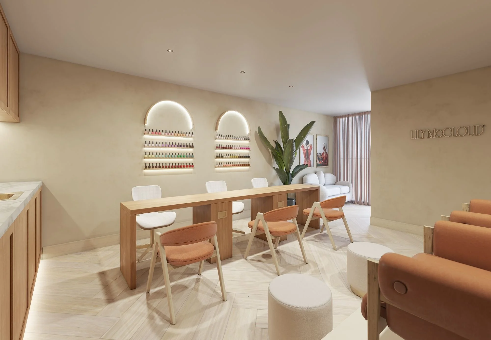 Interior of a nail salon with a long wooden table, white and peach chairs, a white sofa, large green plant, and nail polish display on the wall. The salon has a minimalist design with soft lighting and artwork on the wall.