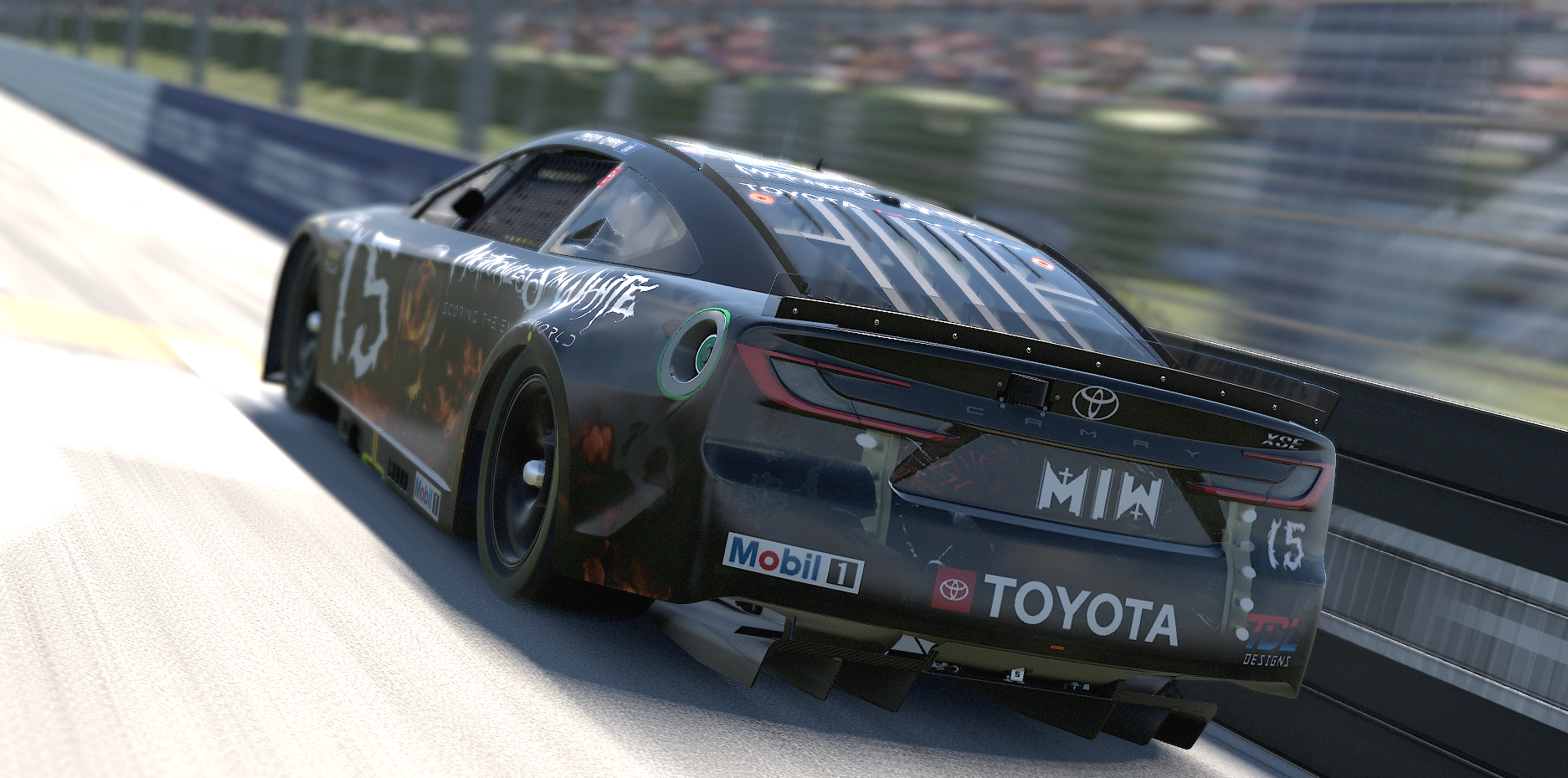 A black Toyota race car on a racetrack with sponsor stickers, including Mobil 1 and Toyota branding, speeding along a curved section with a blurred background.