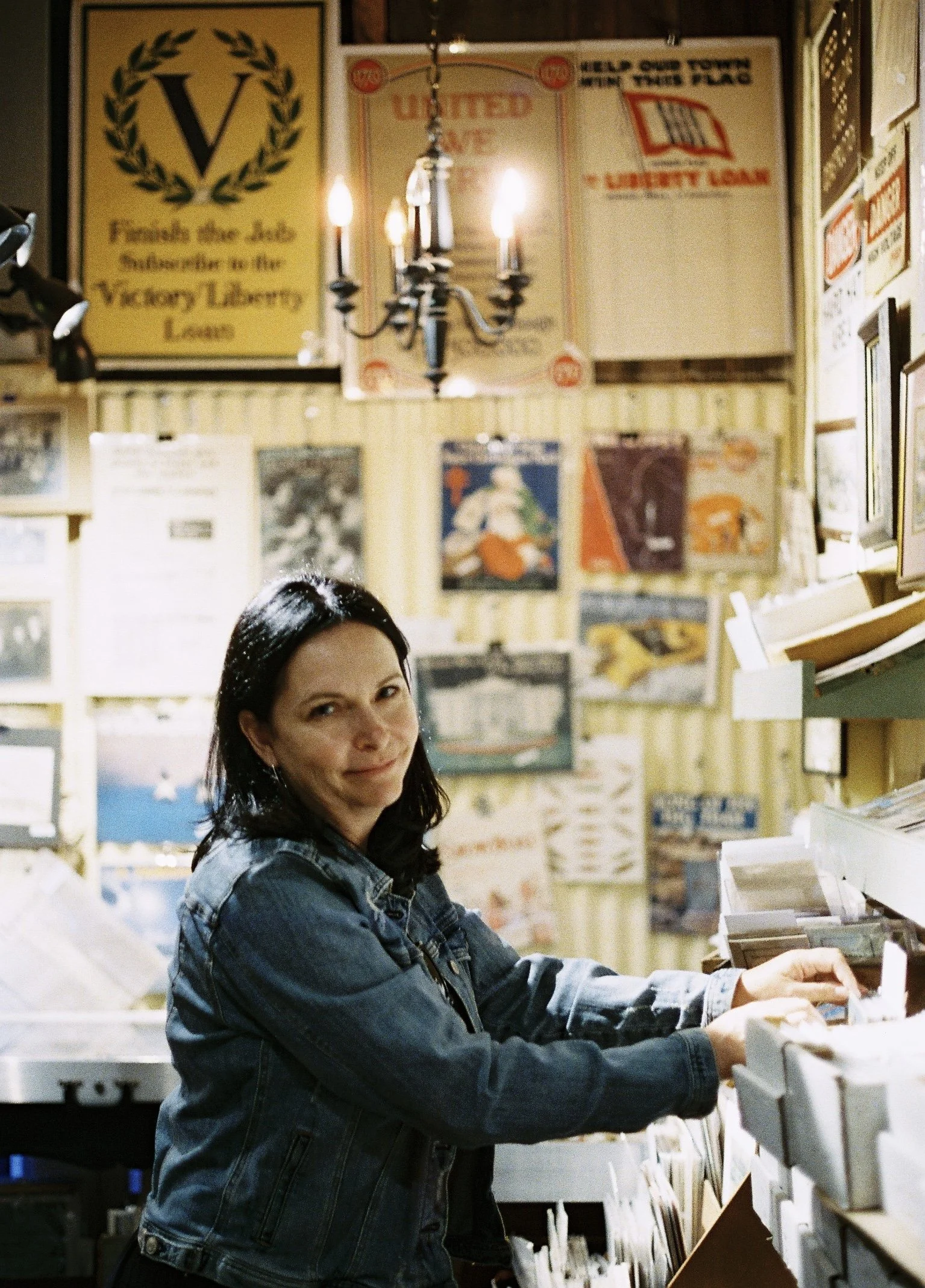 My beautiful mother flipping through old postcards in the coolest antique store not far from our rental